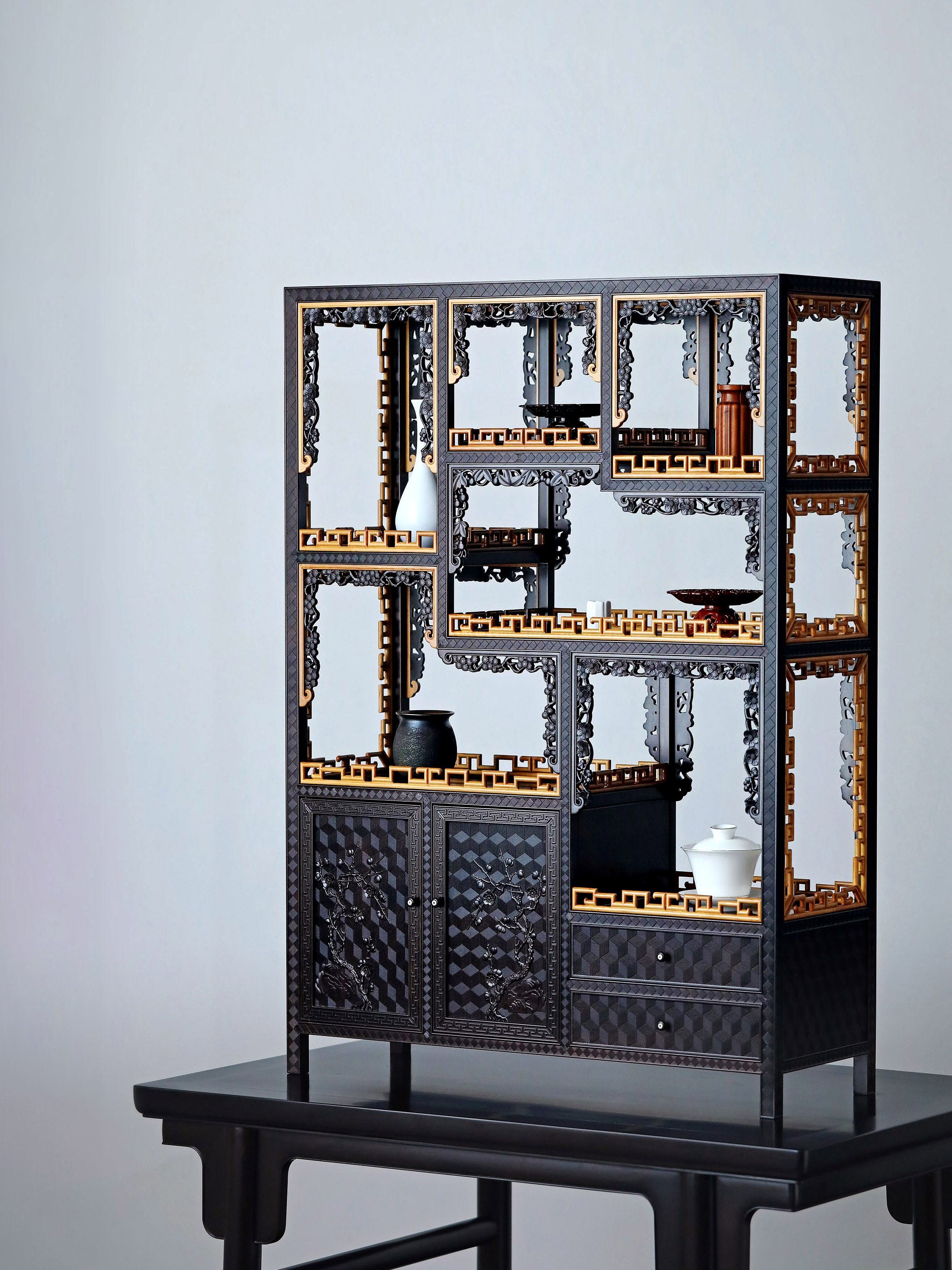 Purple sandalwood table with boxwood brocade pattern and plum blossom branch display shelf