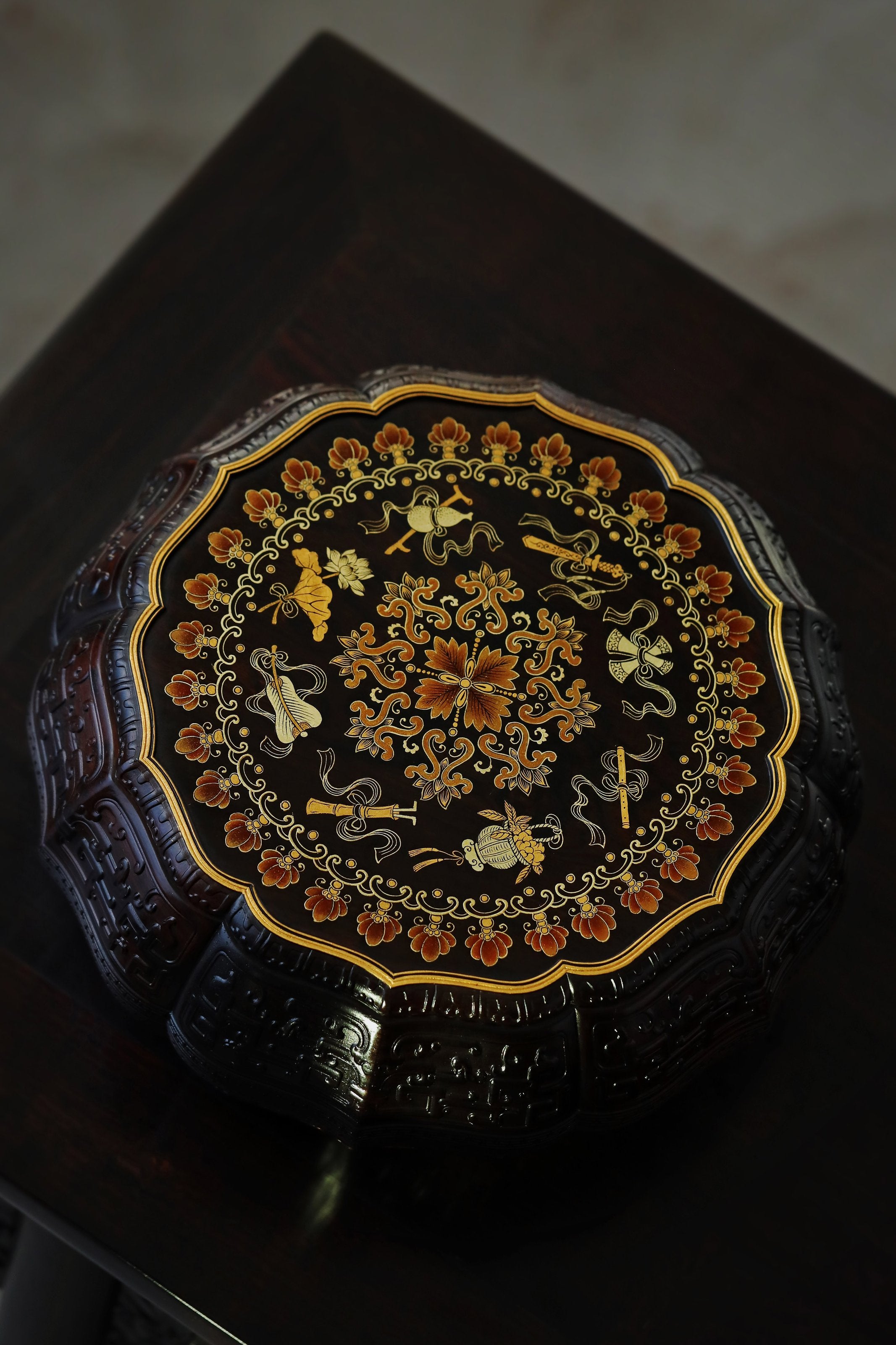 Purple sandalwood twelve-cornered fruit box with gilded Eight Immortals design and sunflower-shaped opening.