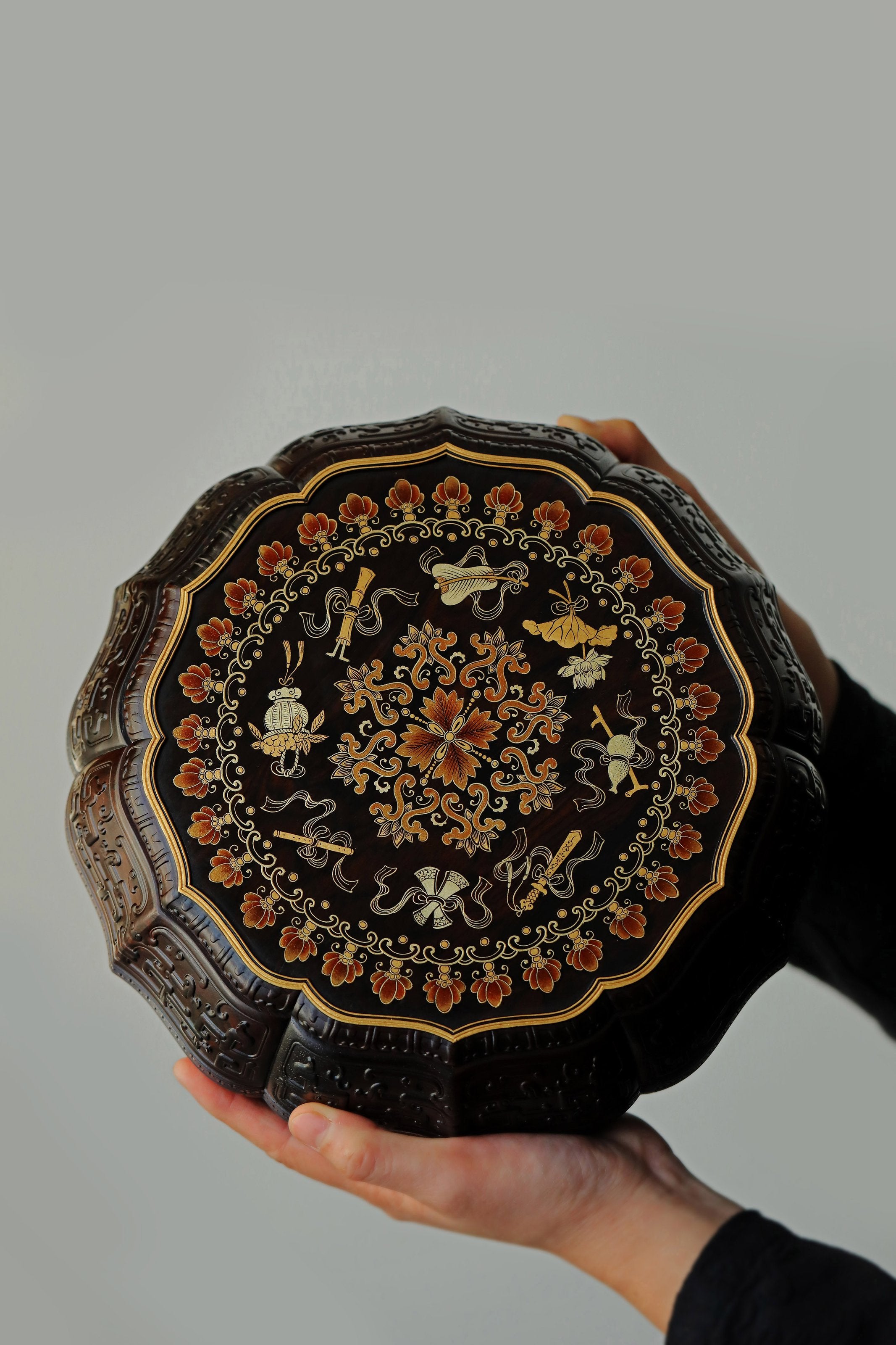 Purple sandalwood twelve-cornered fruit box with gilded Eight Immortals design and sunflower-shaped opening.