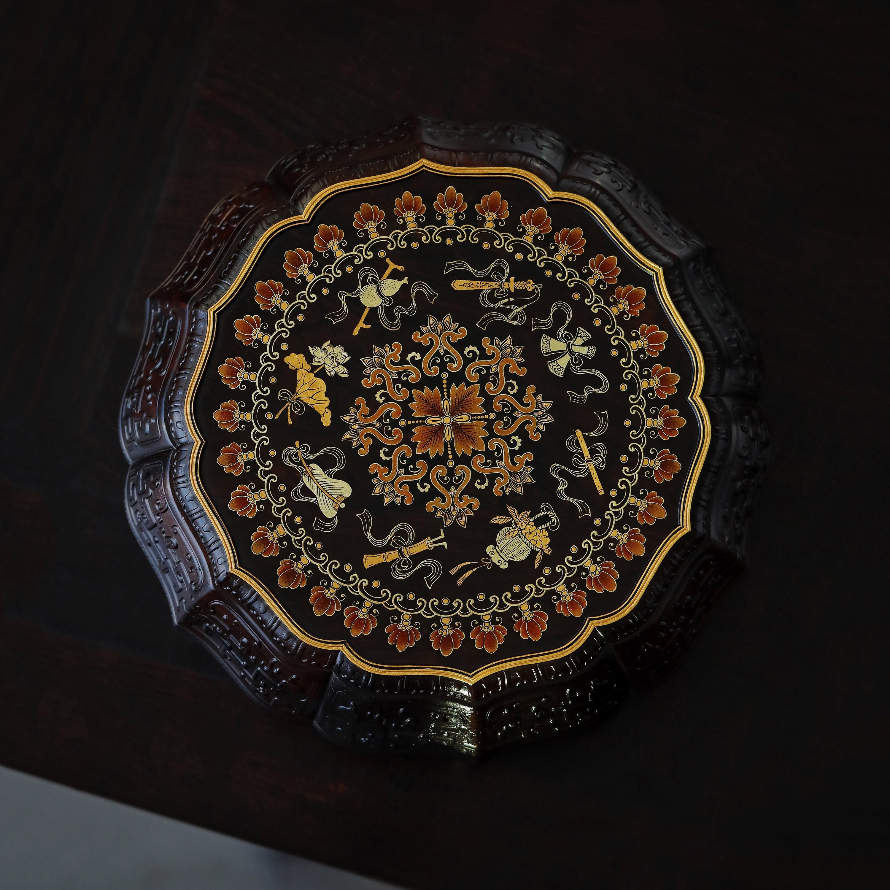 Purple sandalwood twelve-cornered fruit box with gilded Eight Immortals design and sunflower-shaped opening.