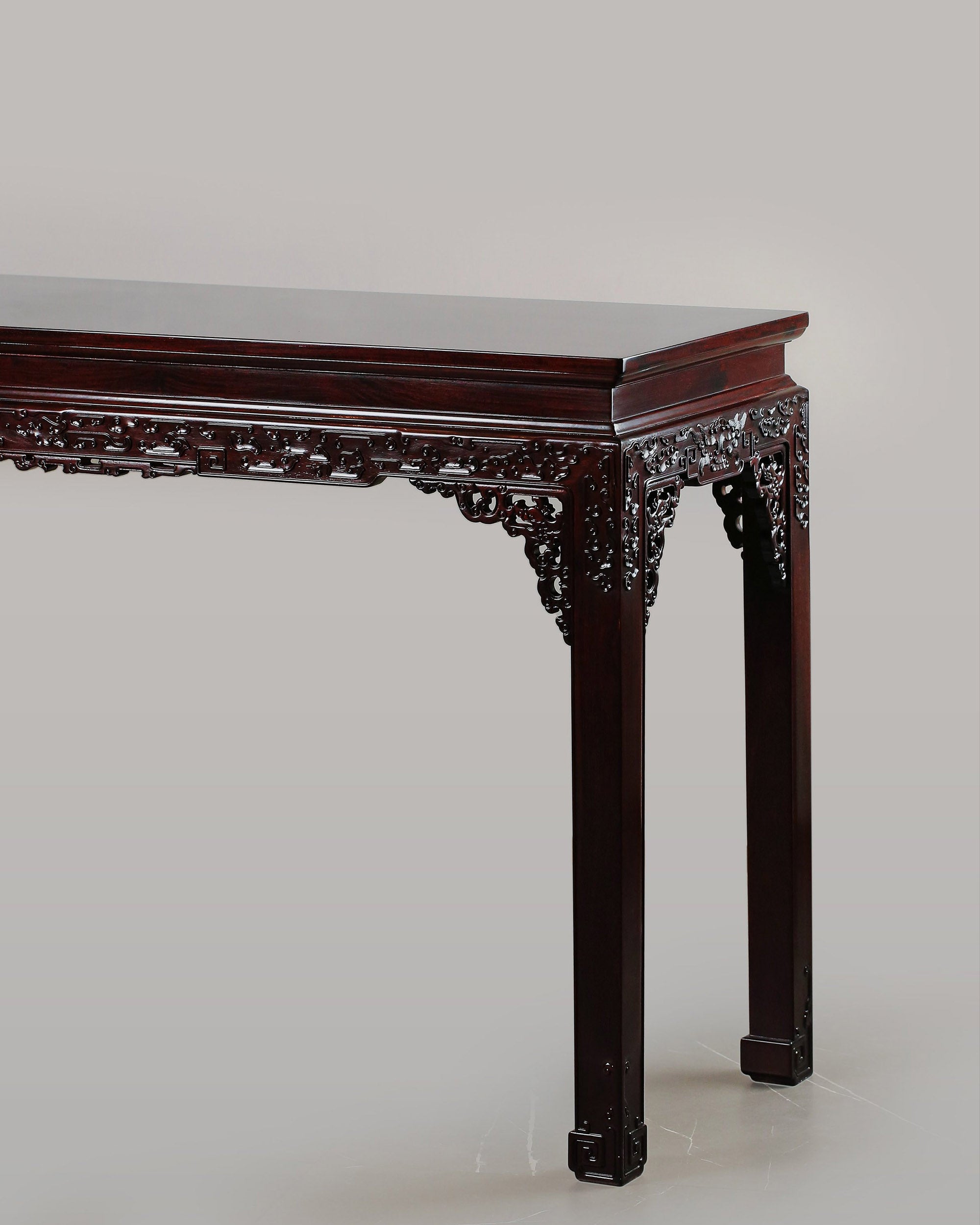 A large rosewood table with taotie design, made for the Qing Dynasty imperial court.