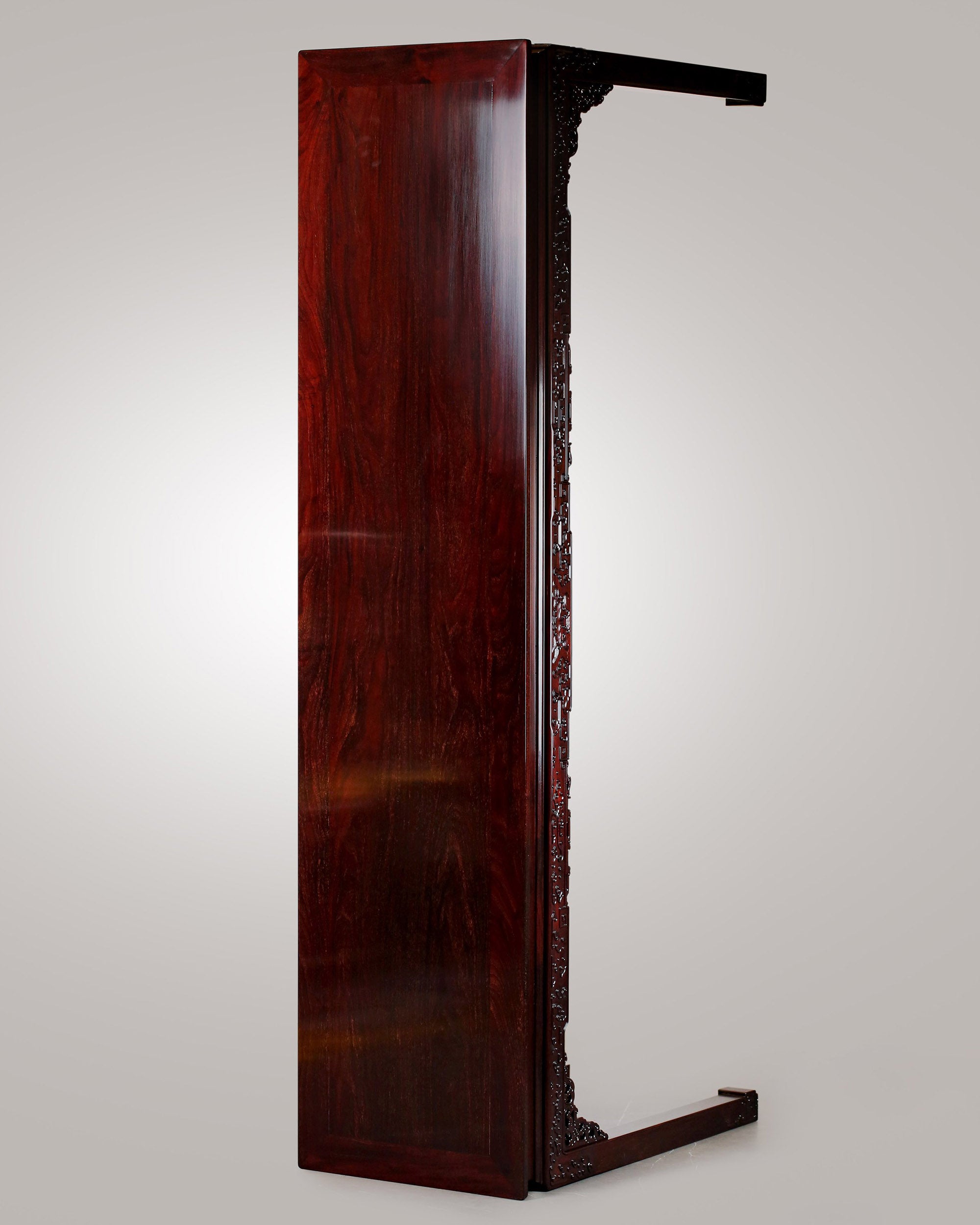 A large rosewood table with taotie design, made for the Qing Dynasty imperial court.