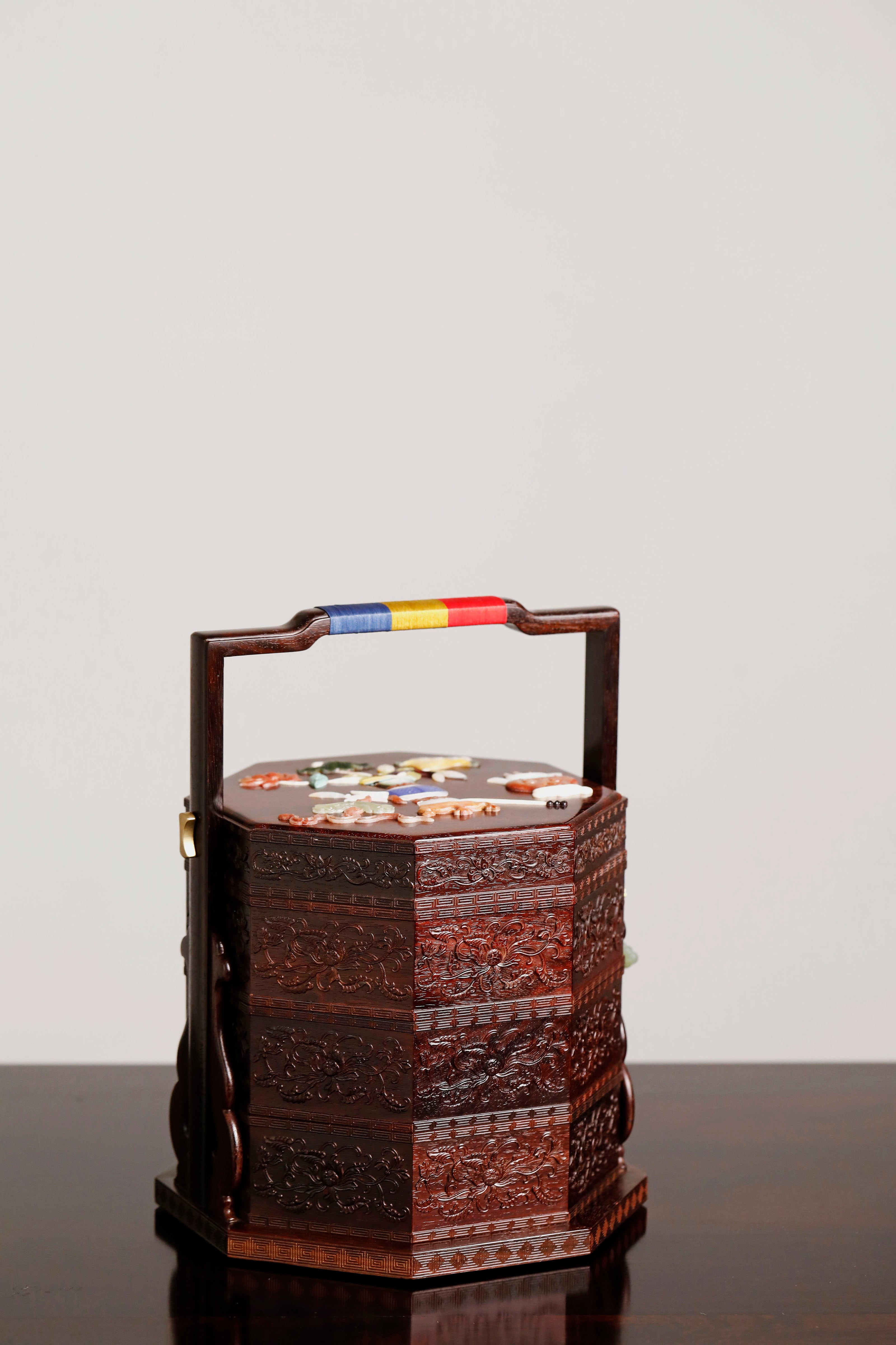 Small-leaf sandalwood octagonal box inlaid with precious stones, symbolizing joy and laughter.