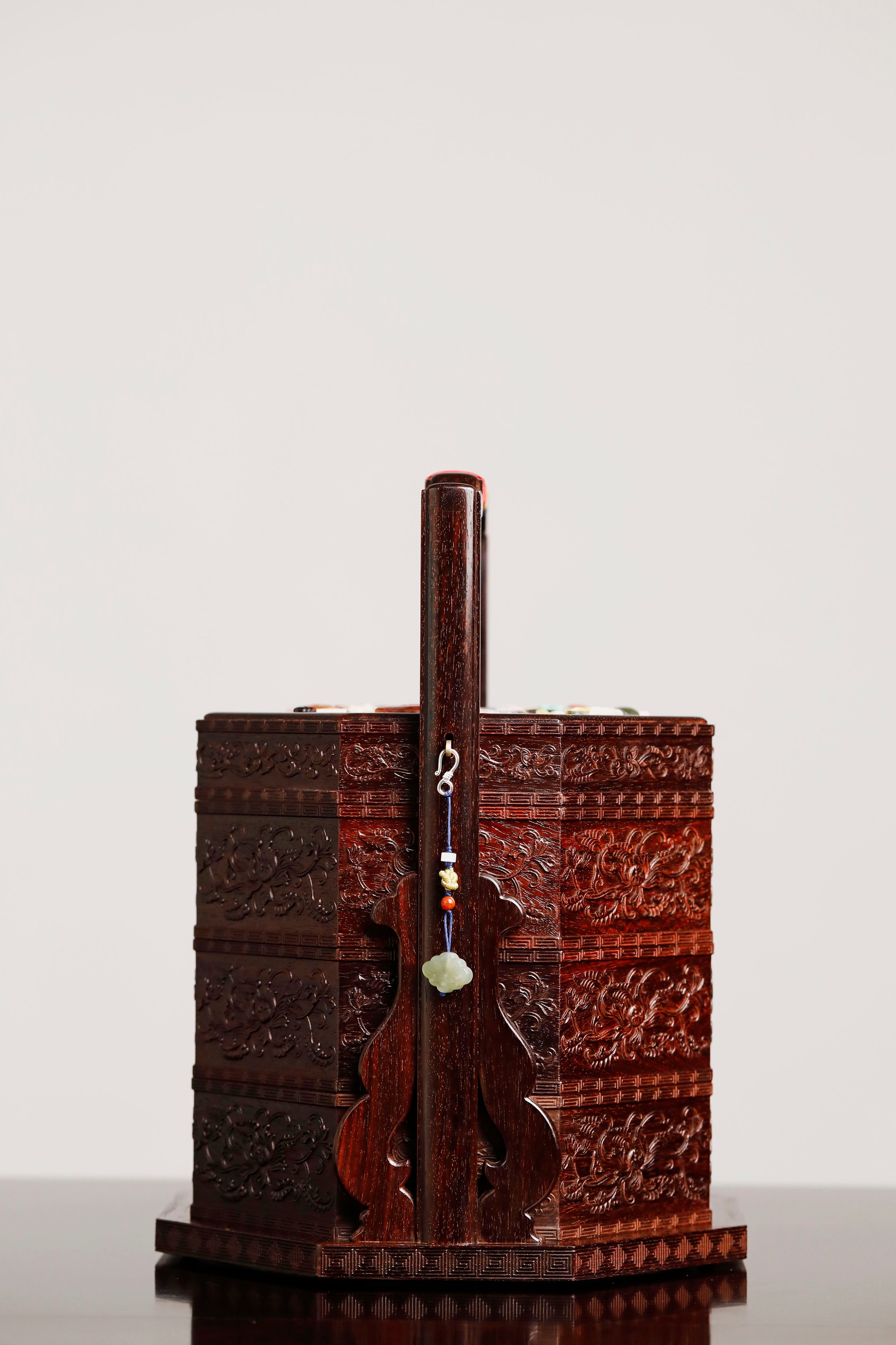 Small-leaf sandalwood octagonal box inlaid with precious stones, symbolizing joy and laughter.