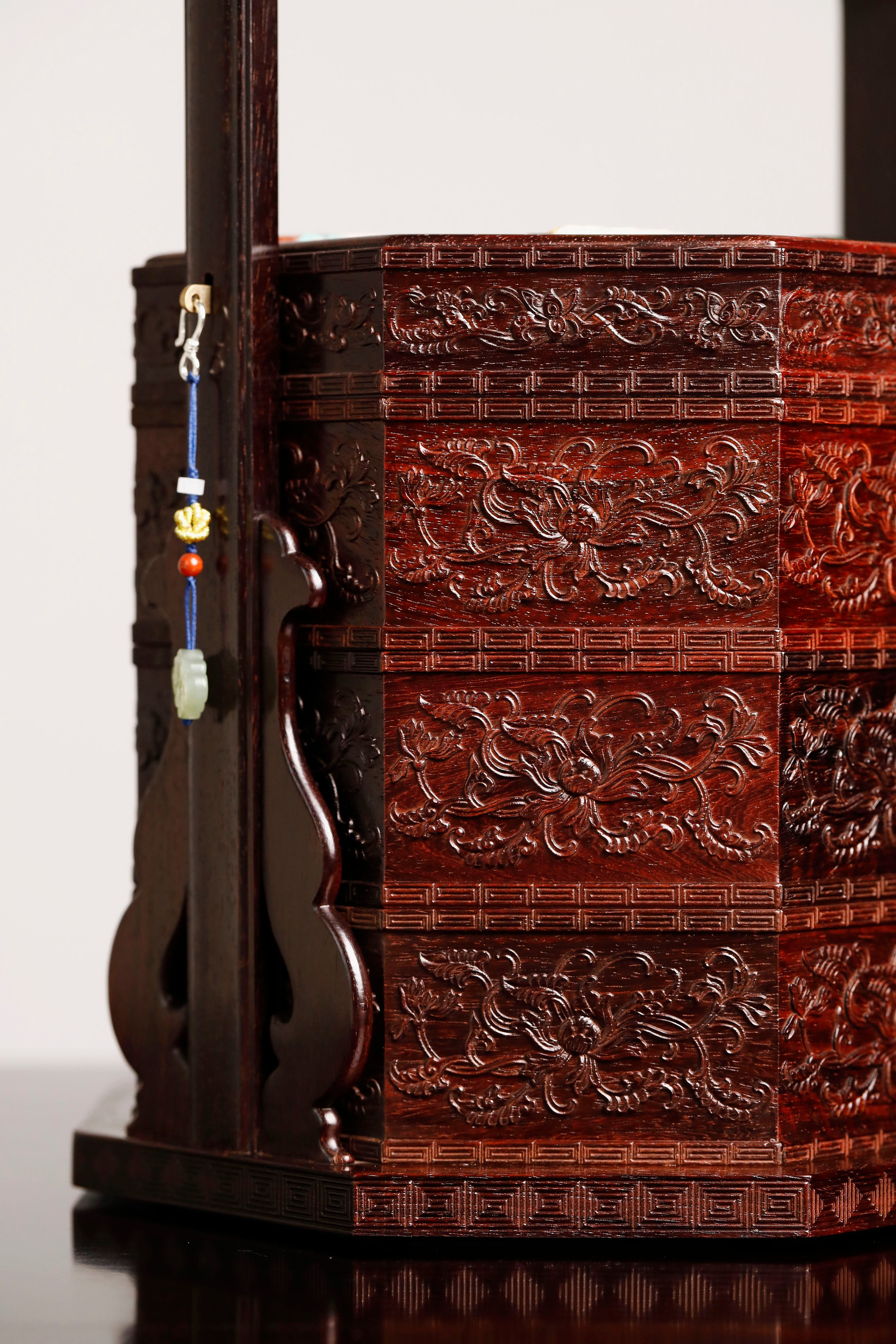 Small-leaf sandalwood octagonal box inlaid with precious stones, symbolizing joy and laughter.