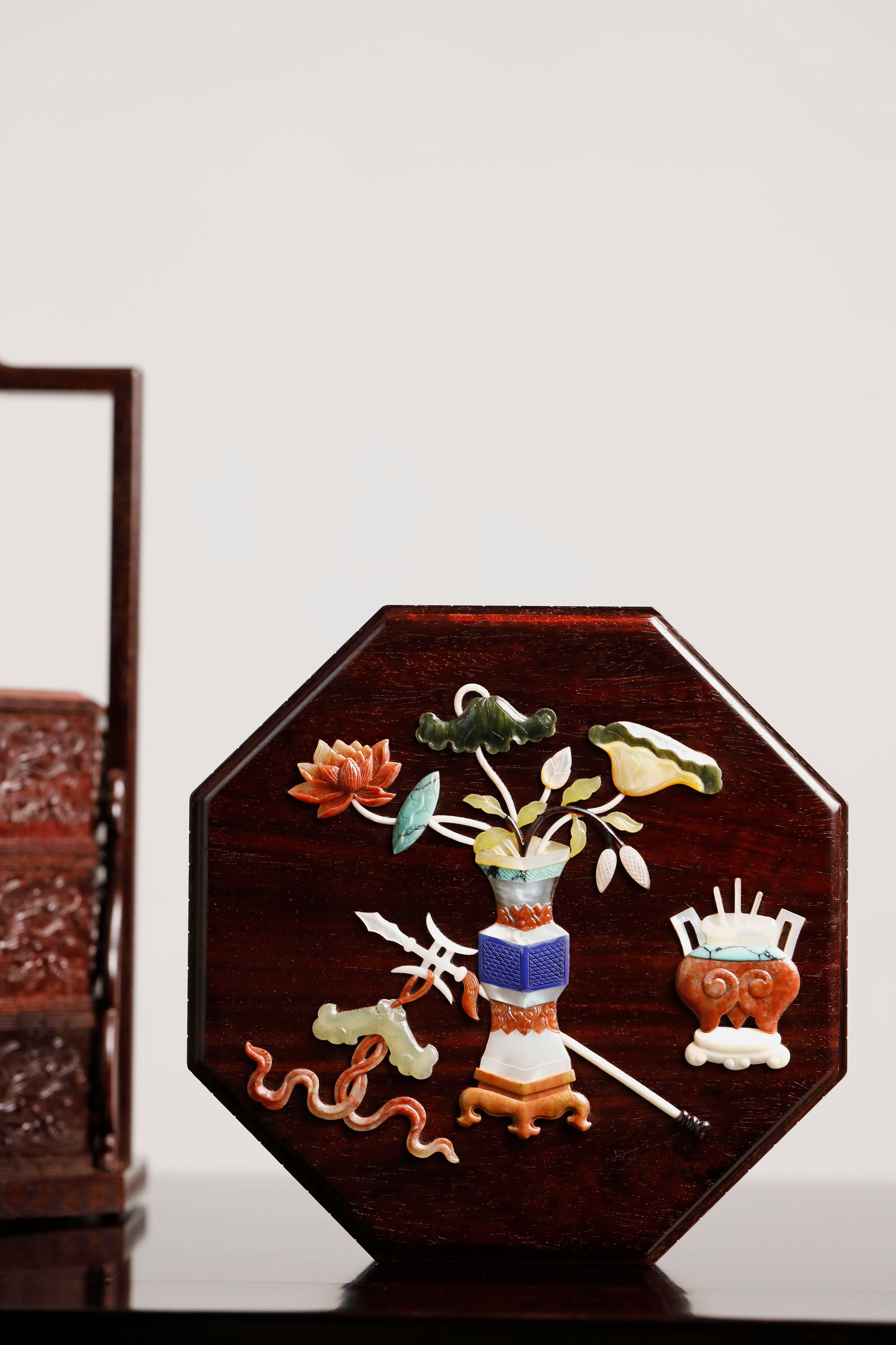 Small-leaf sandalwood octagonal box inlaid with precious stones, symbolizing joy and laughter.
