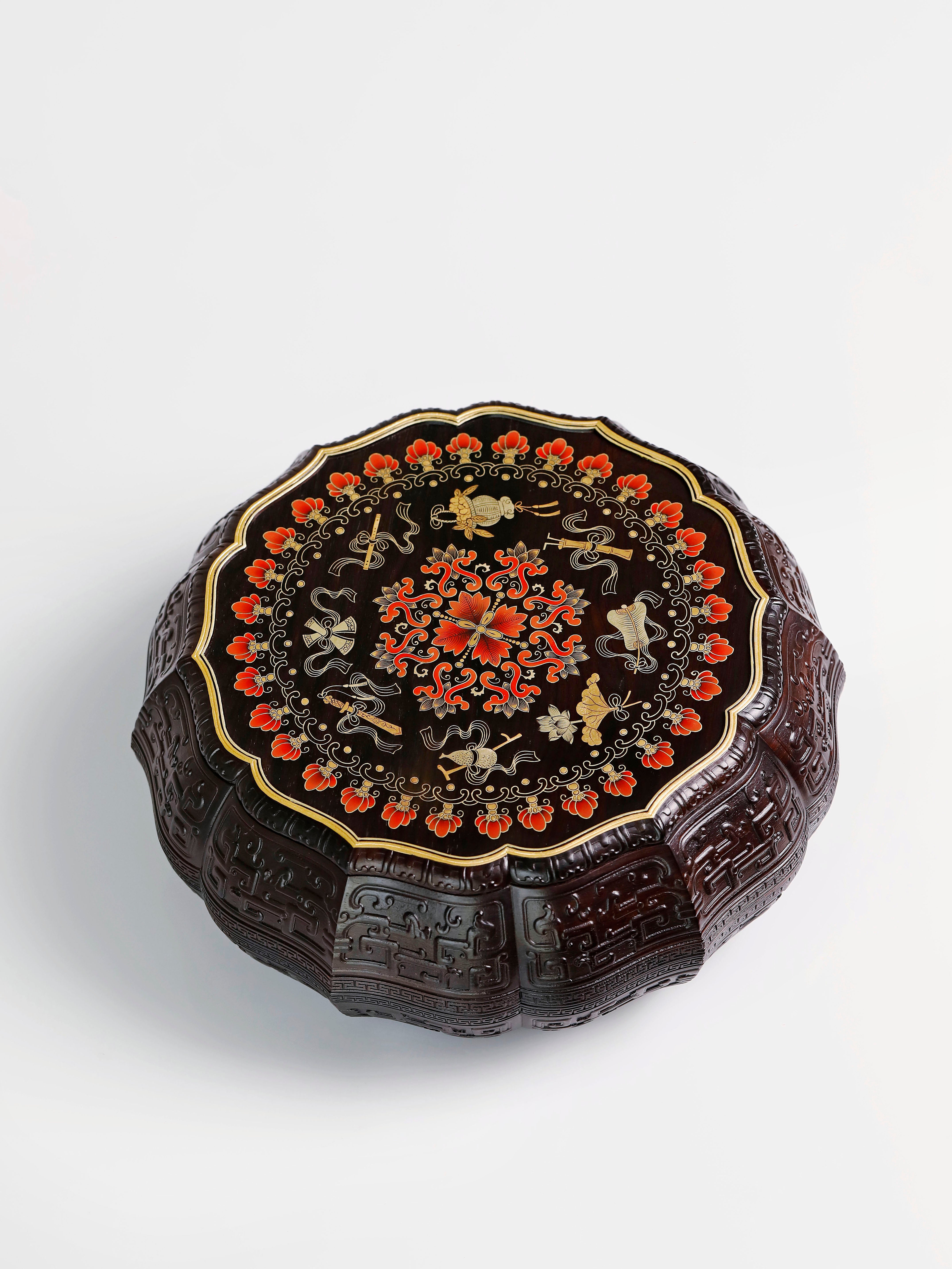 Purple sandalwood twelve-cornered fruit box with gilded Eight Immortals design and sunflower-shaped opening.