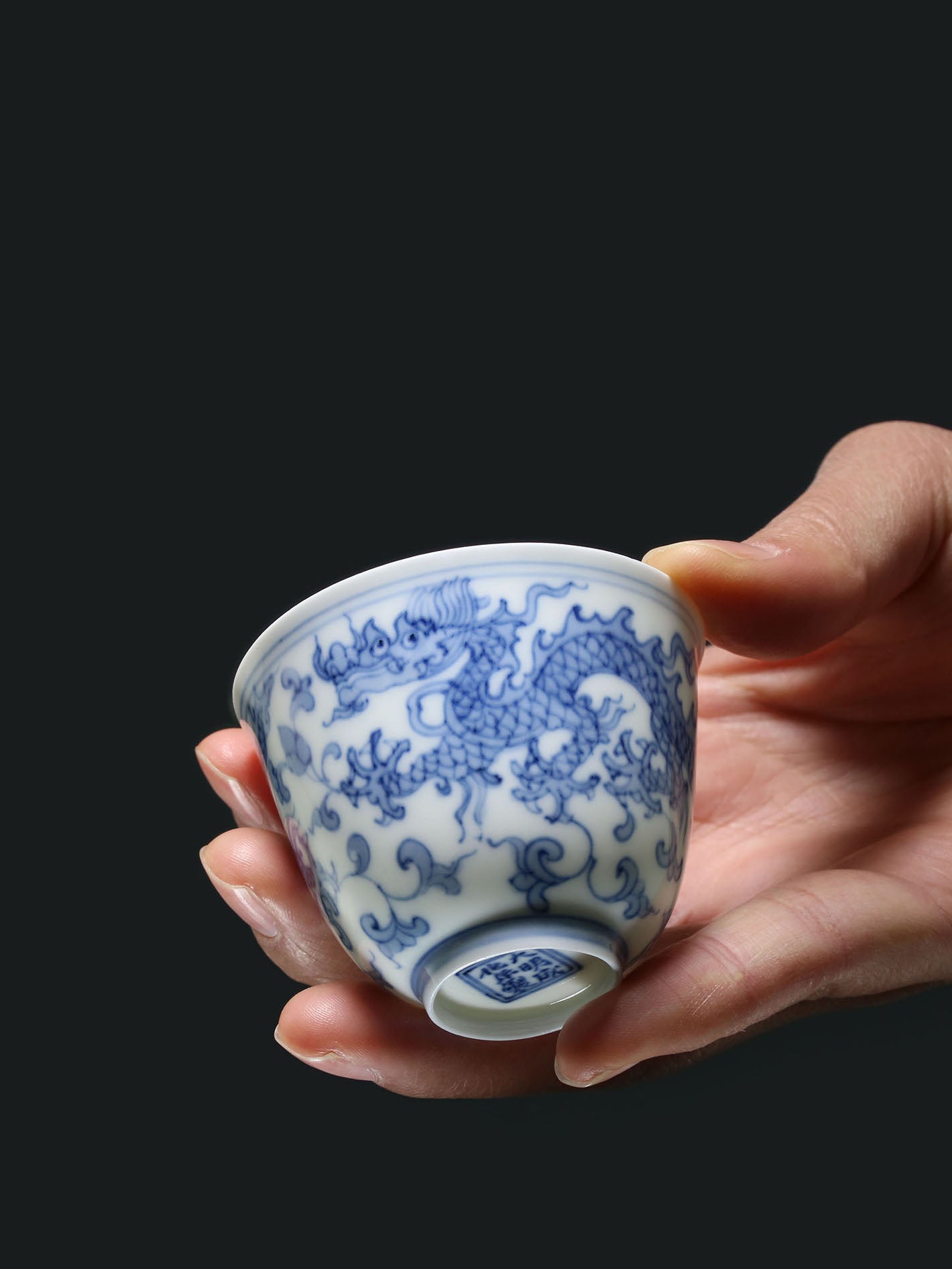 A cup with a flared rim and a design of intertwined dragons.