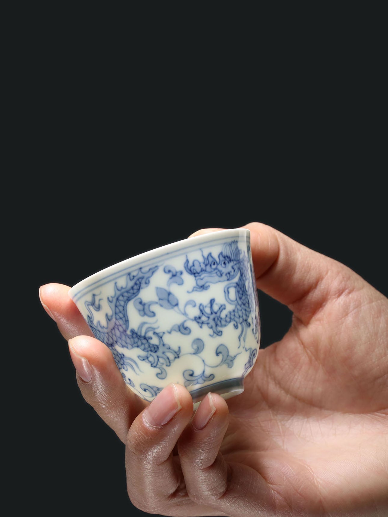 A cup with a flared rim and a design of intertwined dragons.