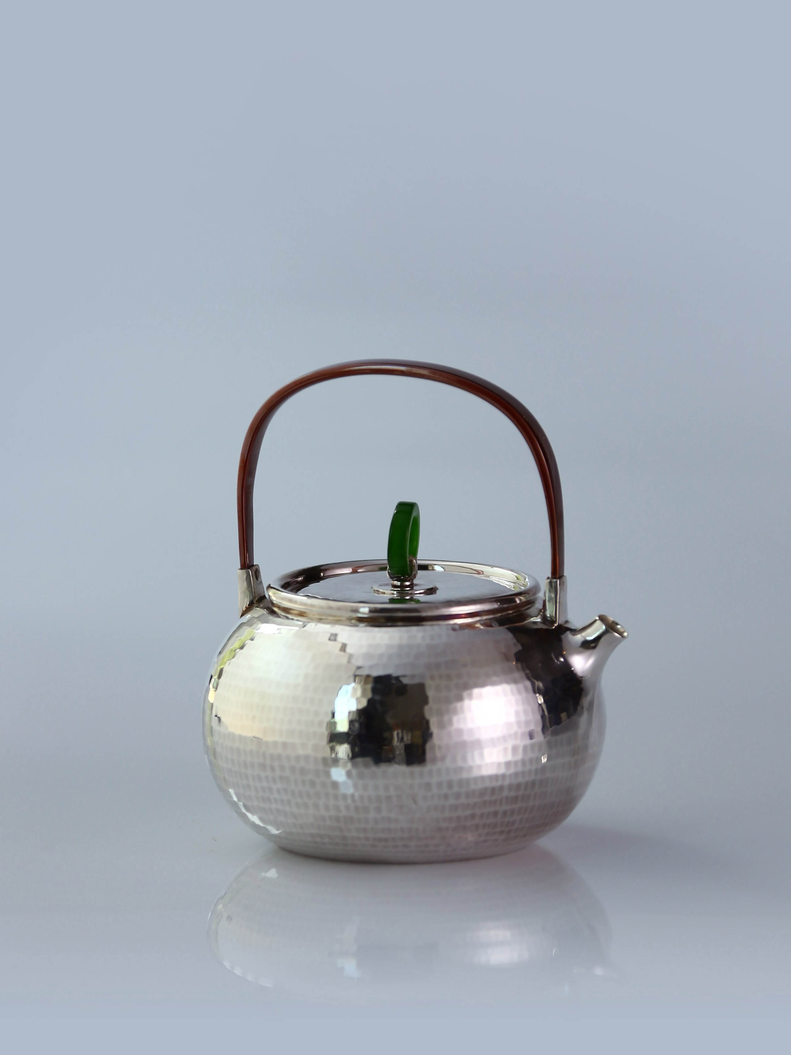 Hammered silver teapot with handle