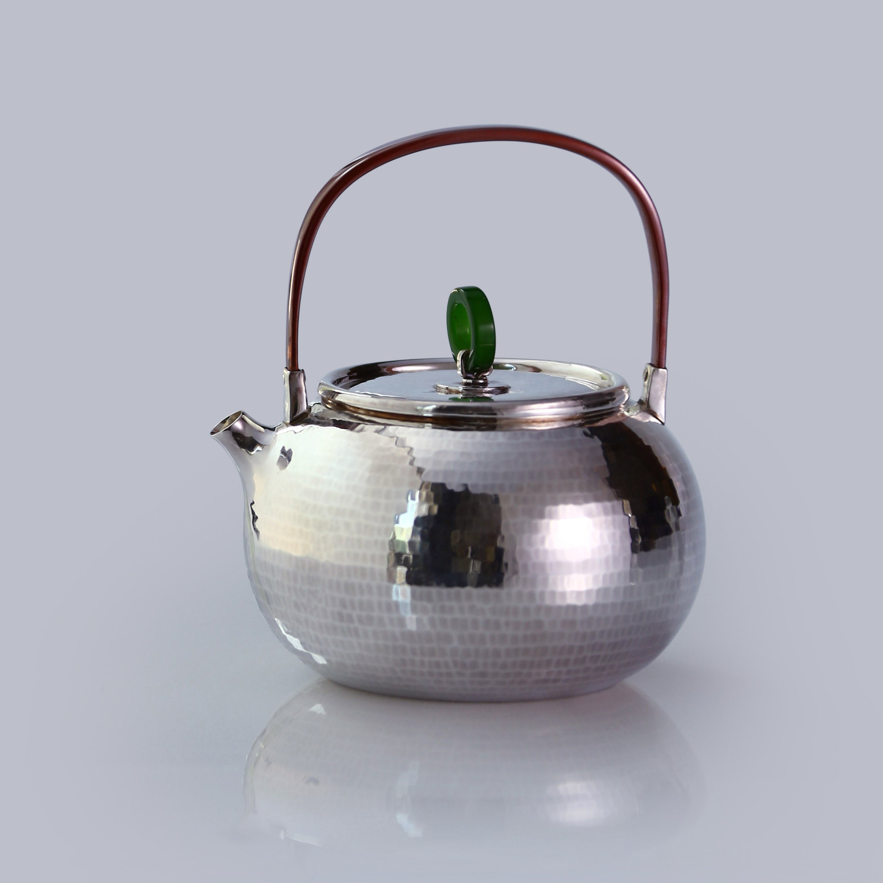 Hammered silver teapot with handle
