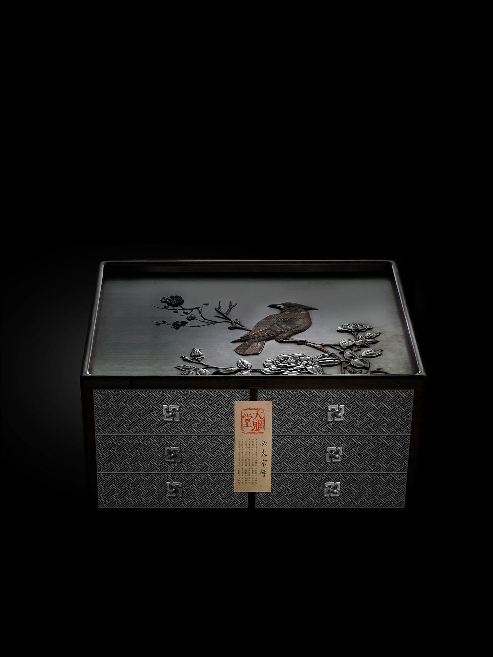 A six-drawer tea box carved with flowers, birds, and swastika patterns on large-leaf sandalwood.