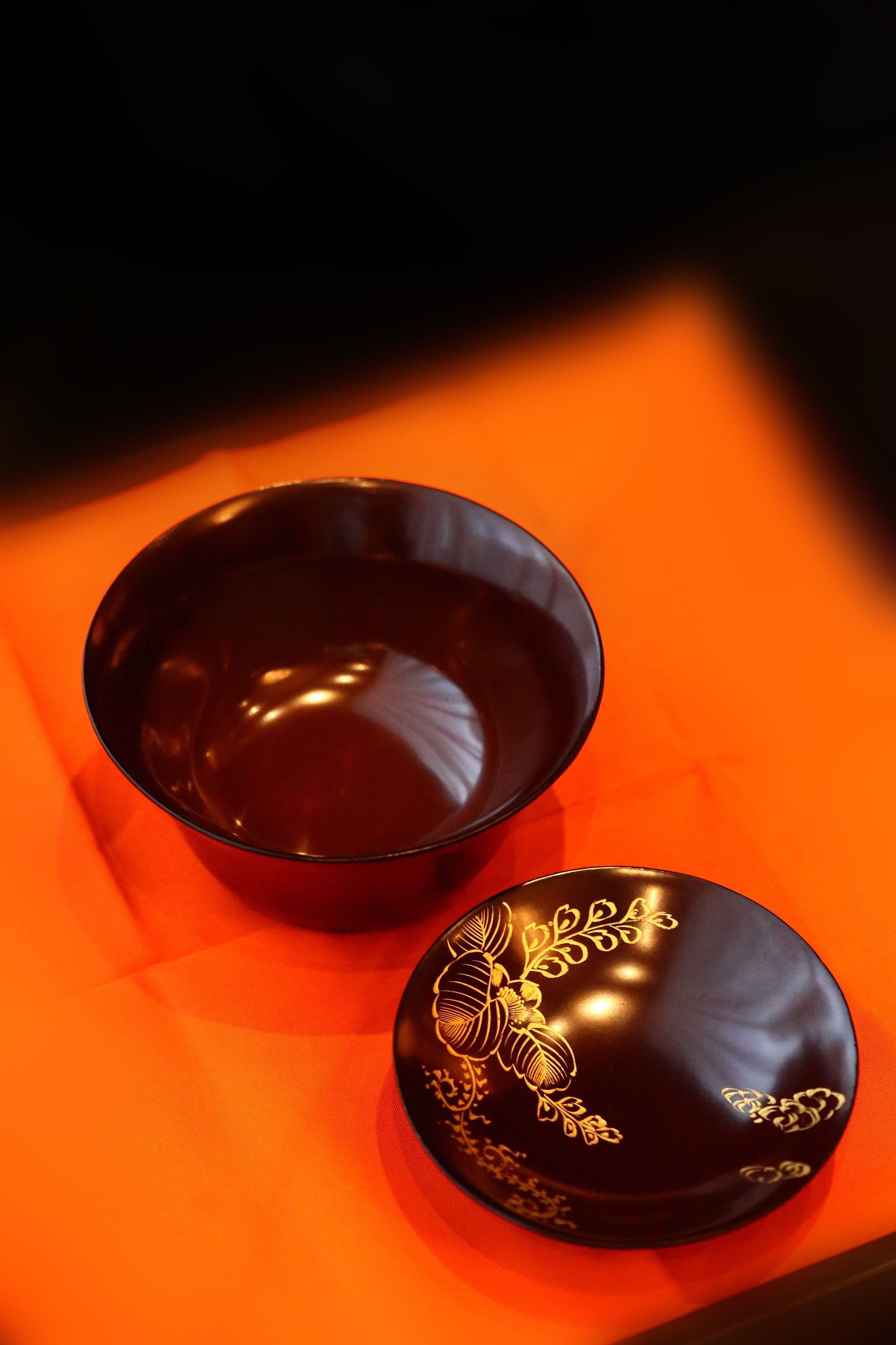 Two lacquered and gold-plated covered bowls