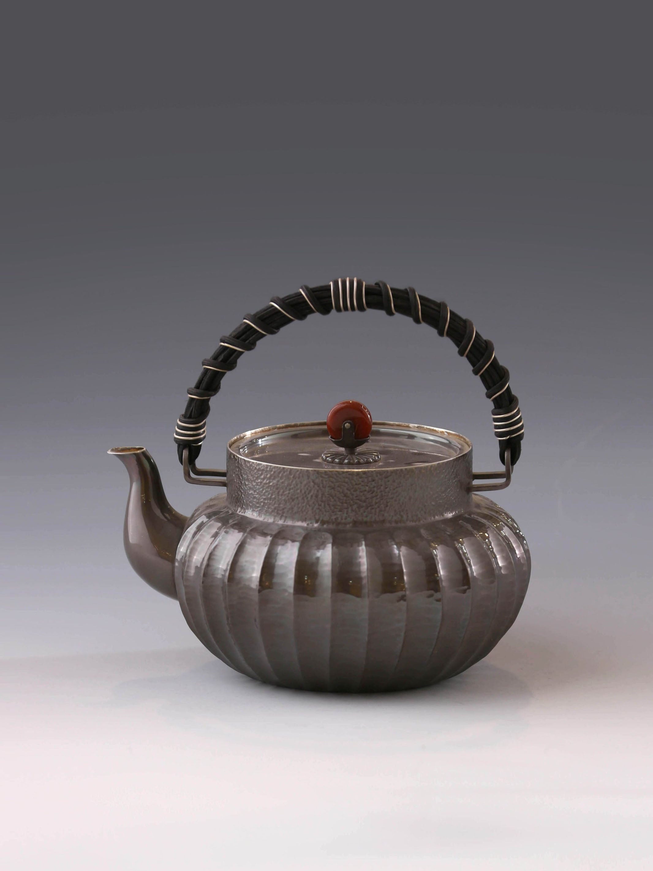 Lantern-shaped silver pot with rattan handle