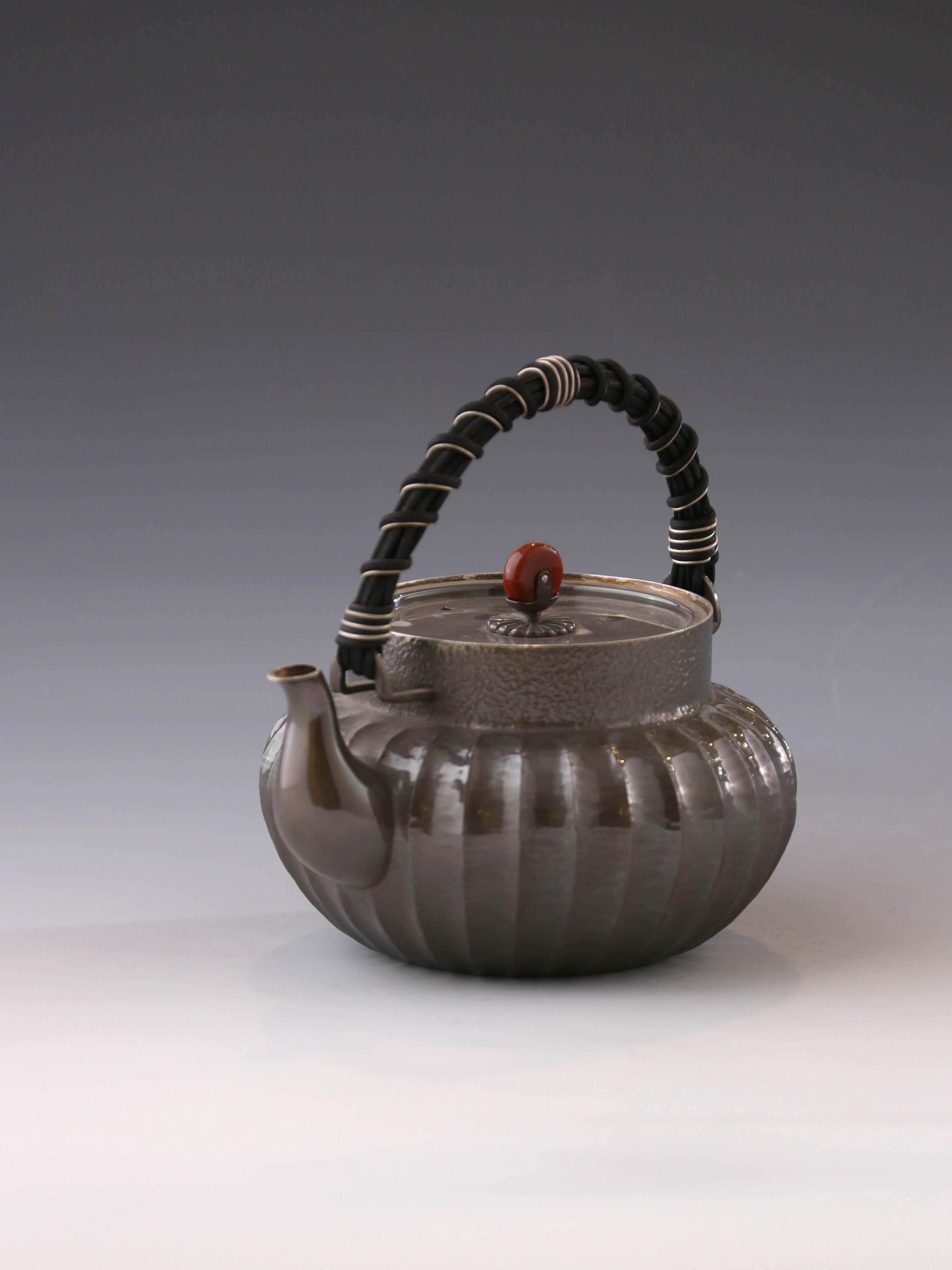 Lantern-shaped silver pot with rattan handle