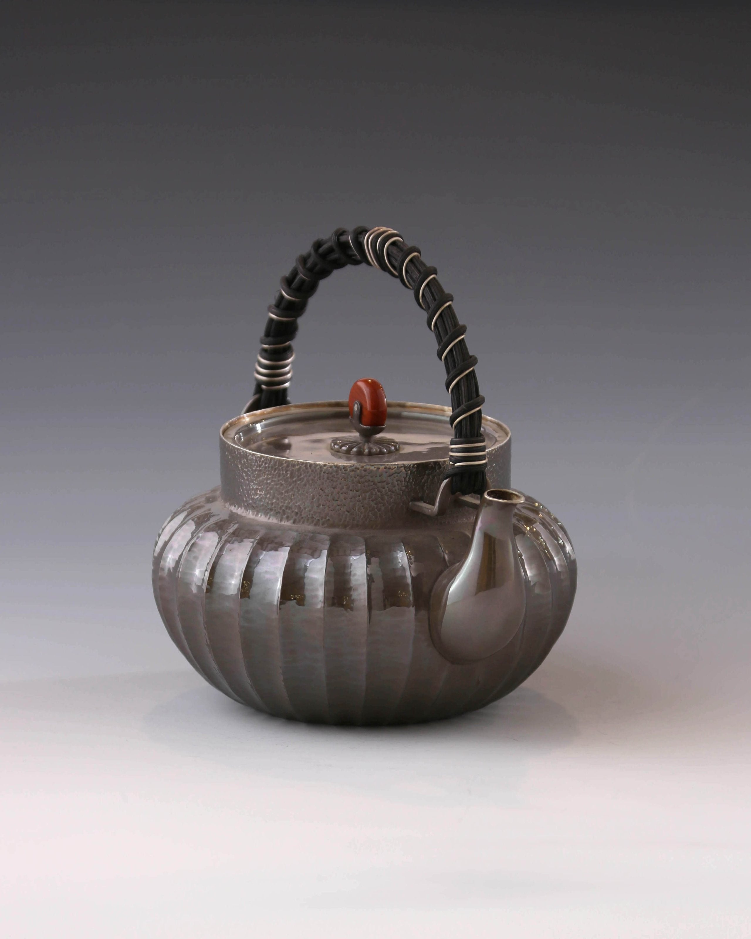 Lantern-shaped silver pot with rattan handle