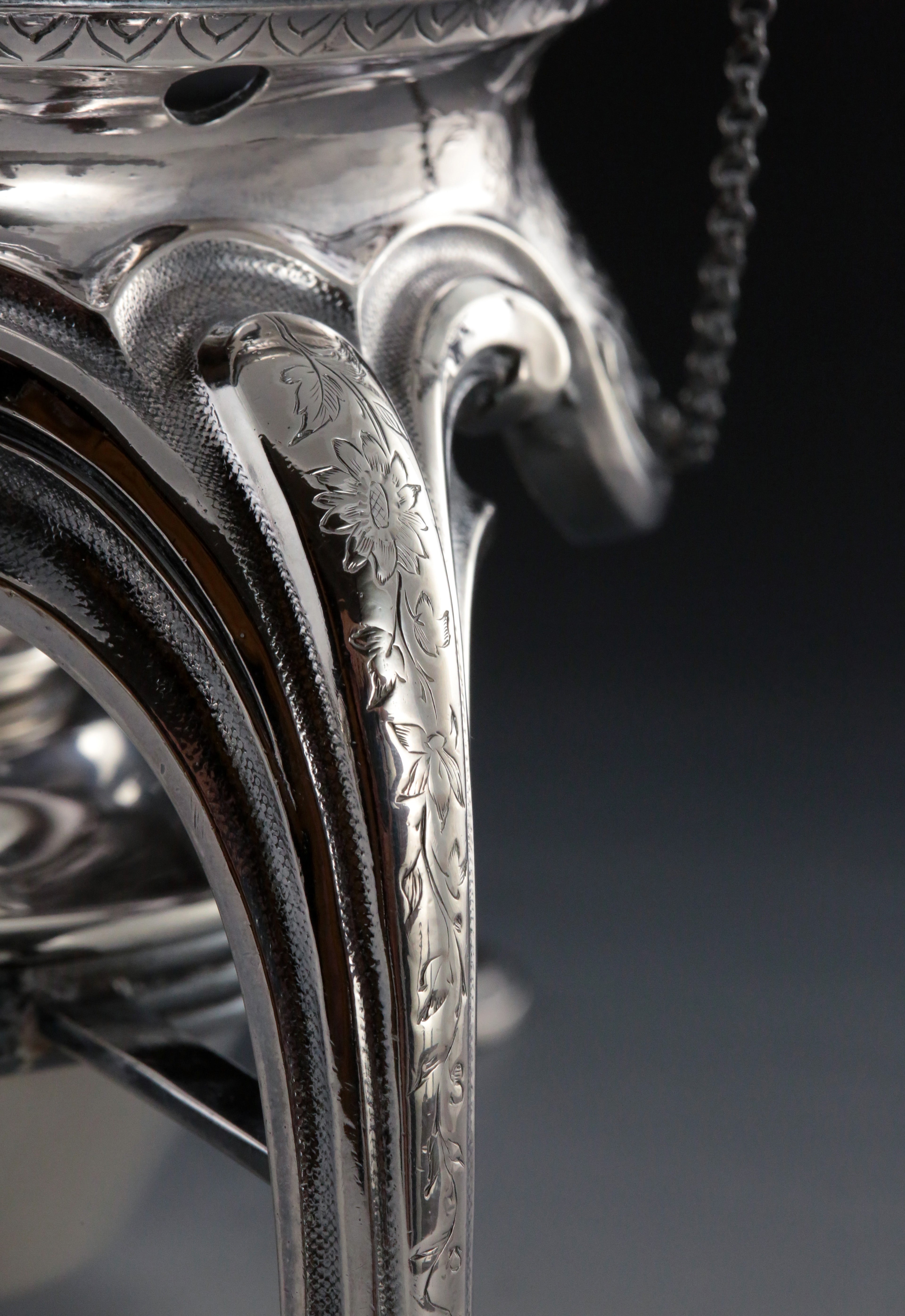 A set of 19th-century French sterling silver tea set featuring a swirling palm leaf pattern.