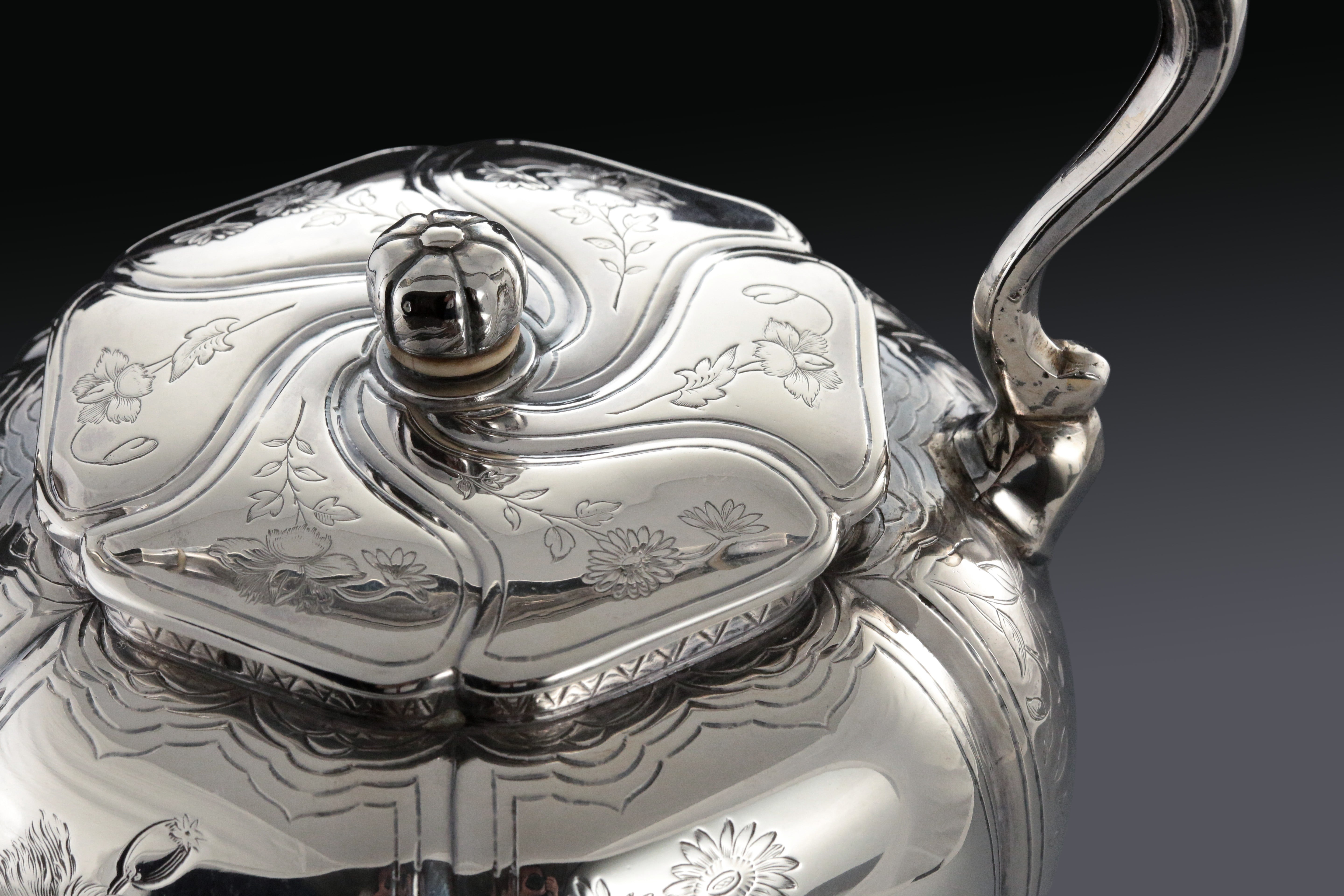 A set of 19th-century French sterling silver tea set featuring a swirling palm leaf pattern.