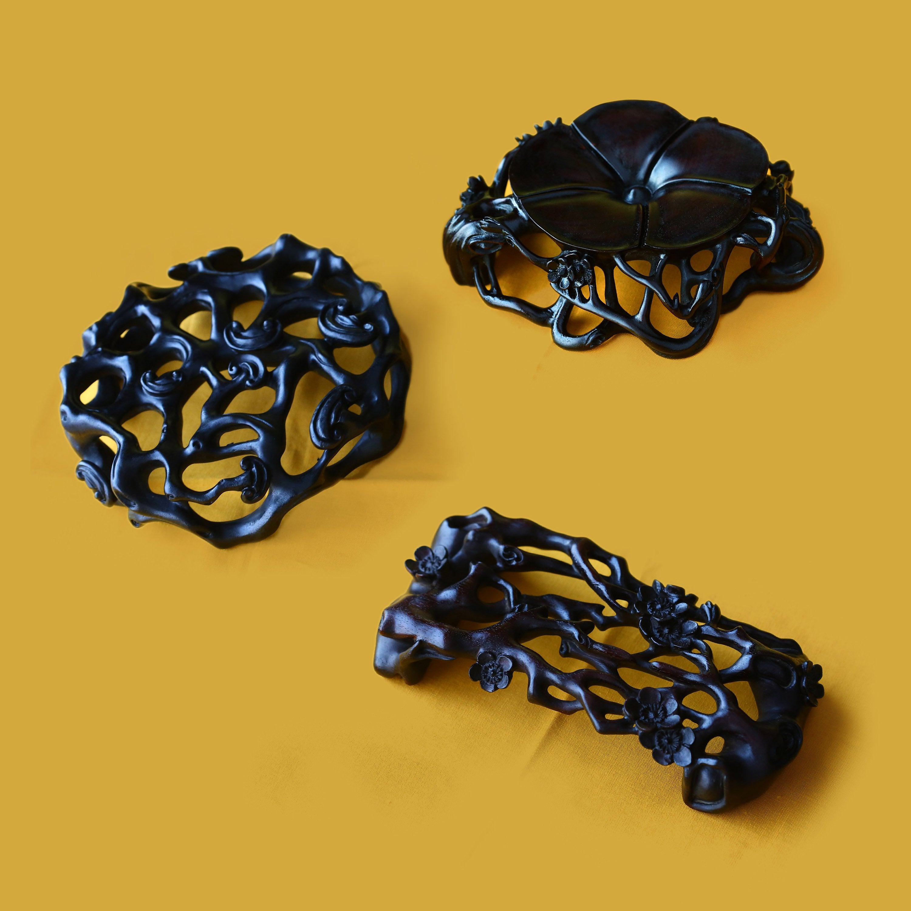 Three pieces with rosewood base featuring plum blossom, lingzhi, and begonia patterns.