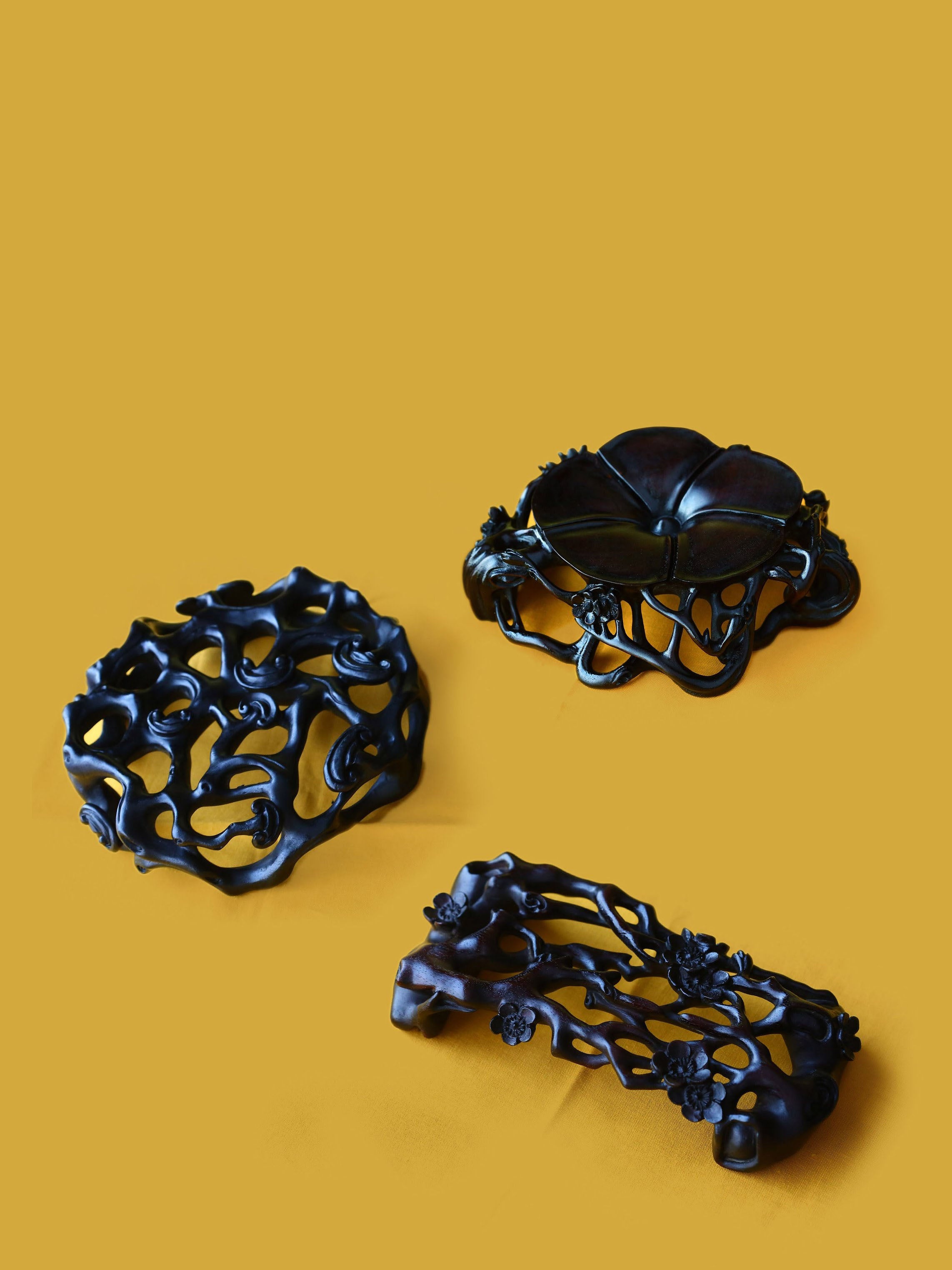 Three pieces with rosewood base featuring plum blossom, lingzhi, and begonia patterns.