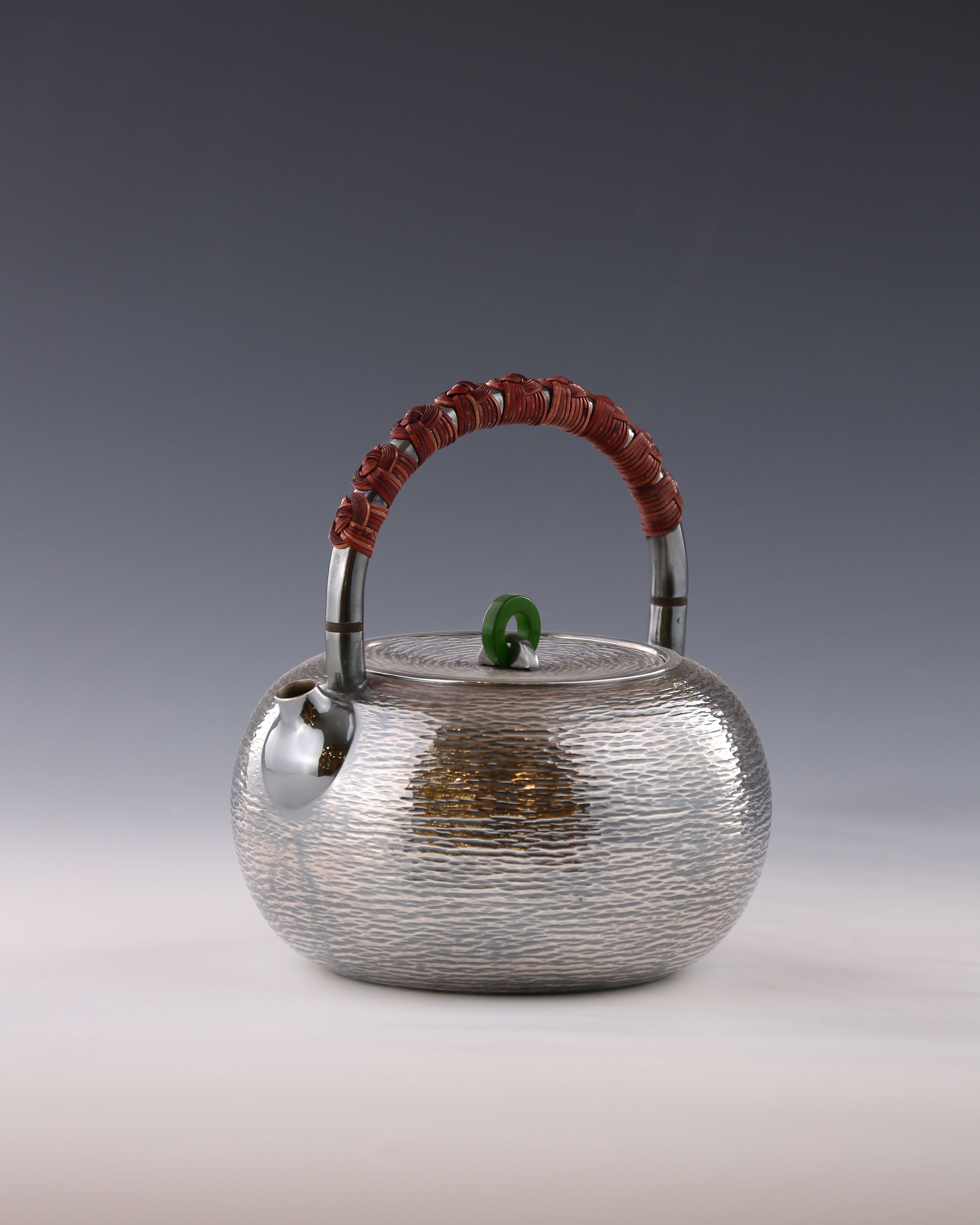 Silver teapot with horizontal stripes and heat insulation handle