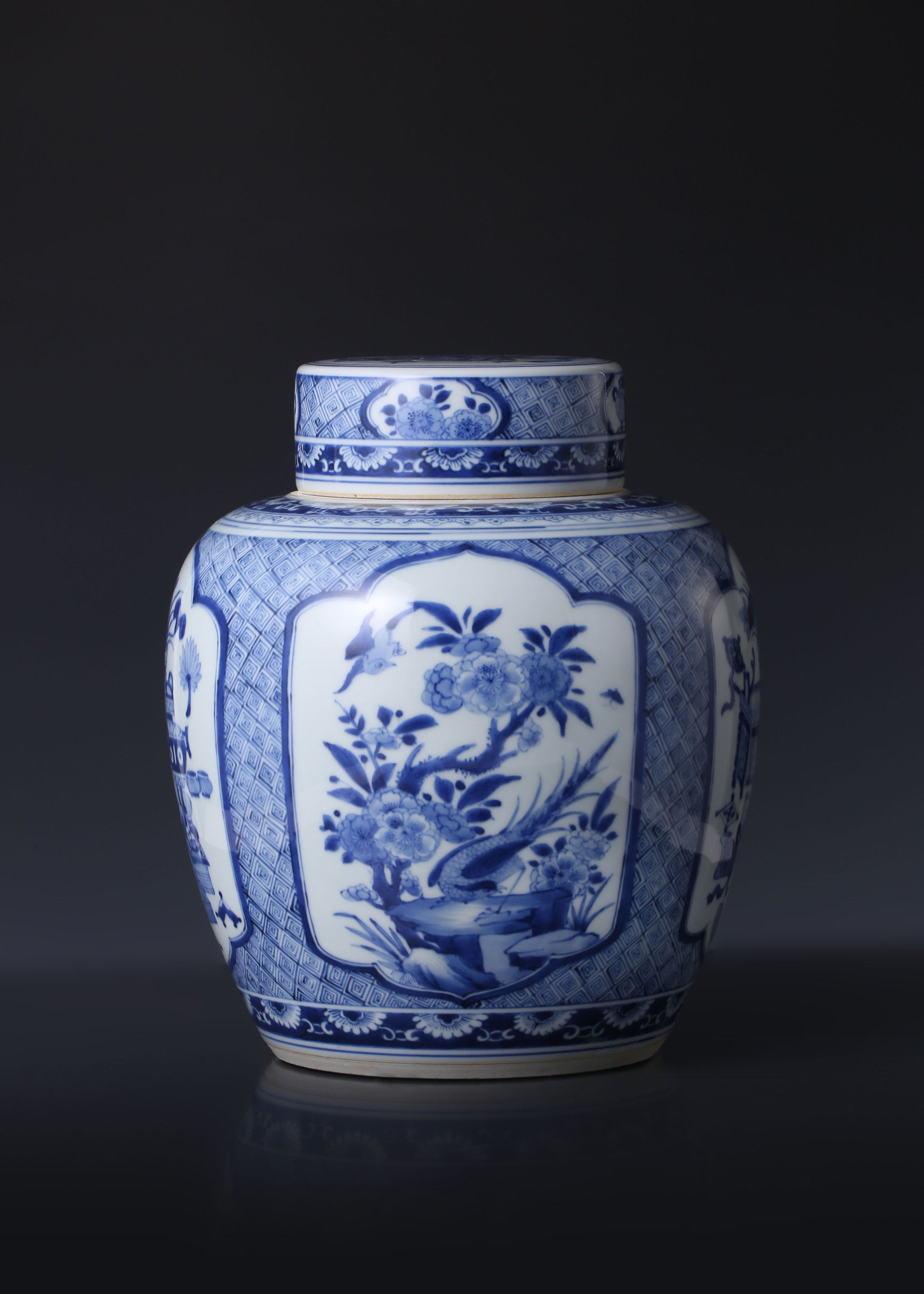 Kangxi blue and white porcelain tea caddy with four openwork panels depicting antique flowers and birds.