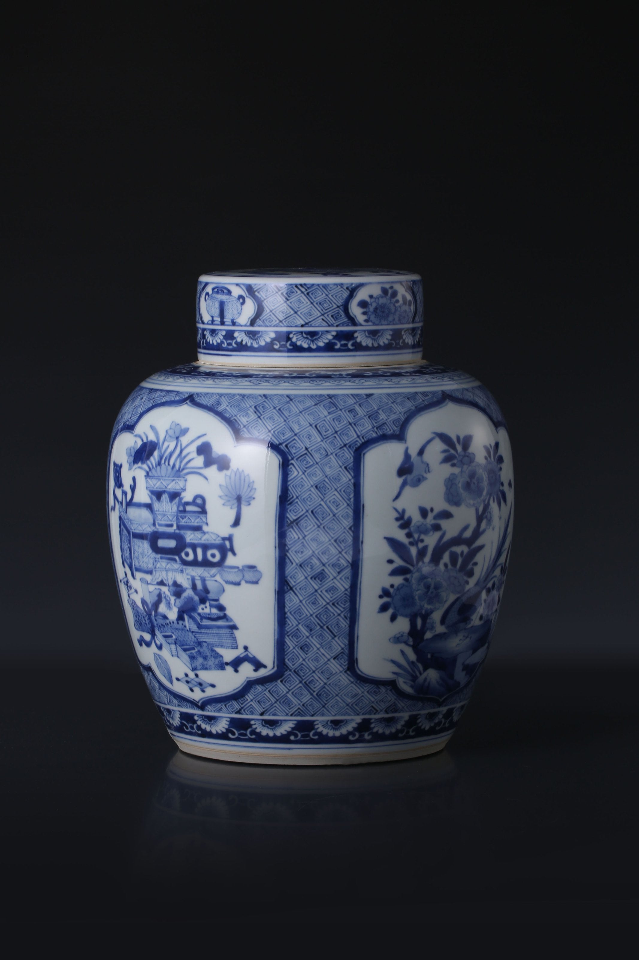 Kangxi blue and white porcelain tea caddy with four openwork panels depicting antique flowers and birds.