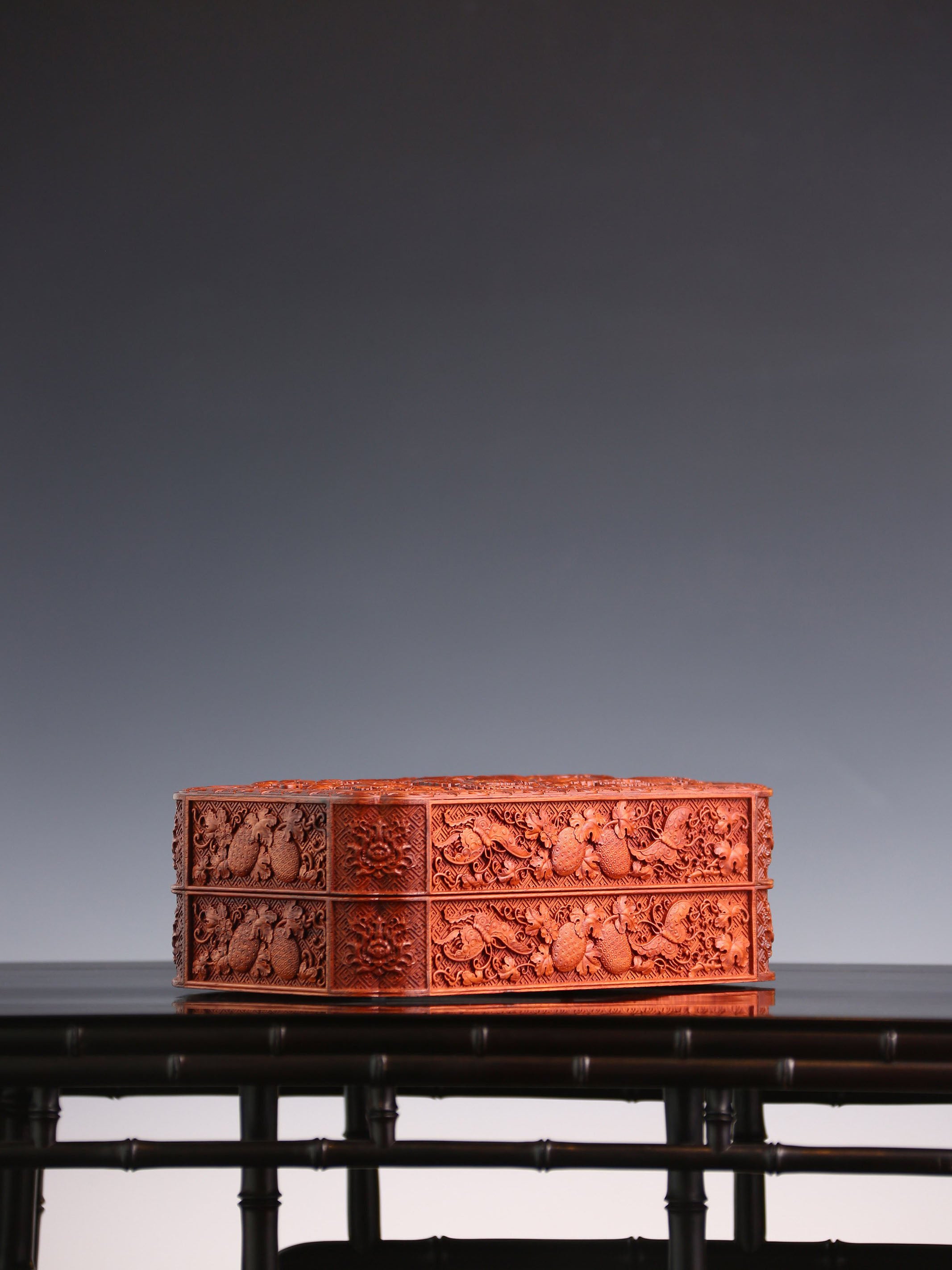 Tea box with full carving of lychee, butterfly, and dragon patterns