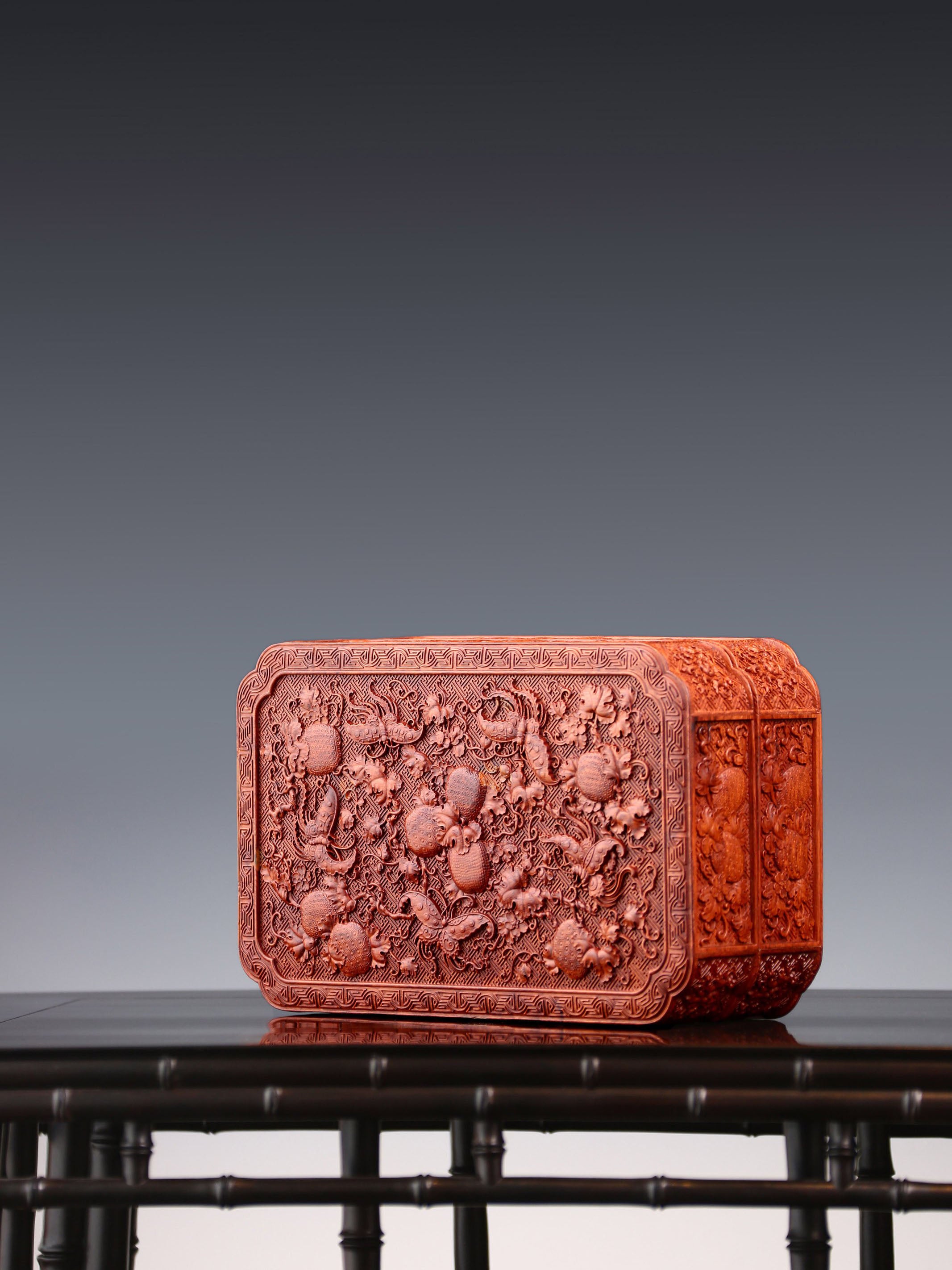 Tea box with full carving of lychee, butterfly, and dragon patterns