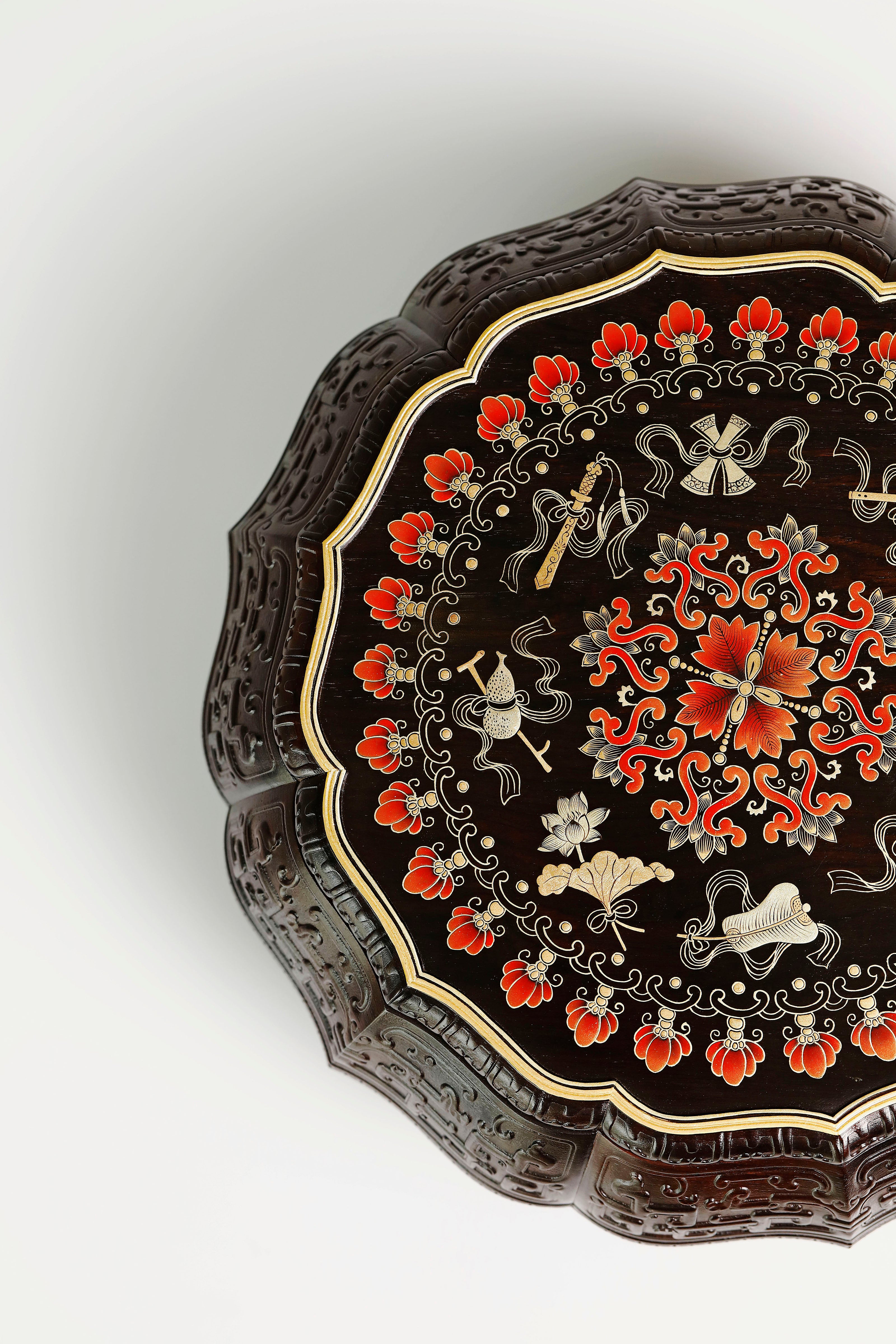 Purple sandalwood twelve-cornered fruit box with gilded Eight Immortals design and sunflower-shaped opening.