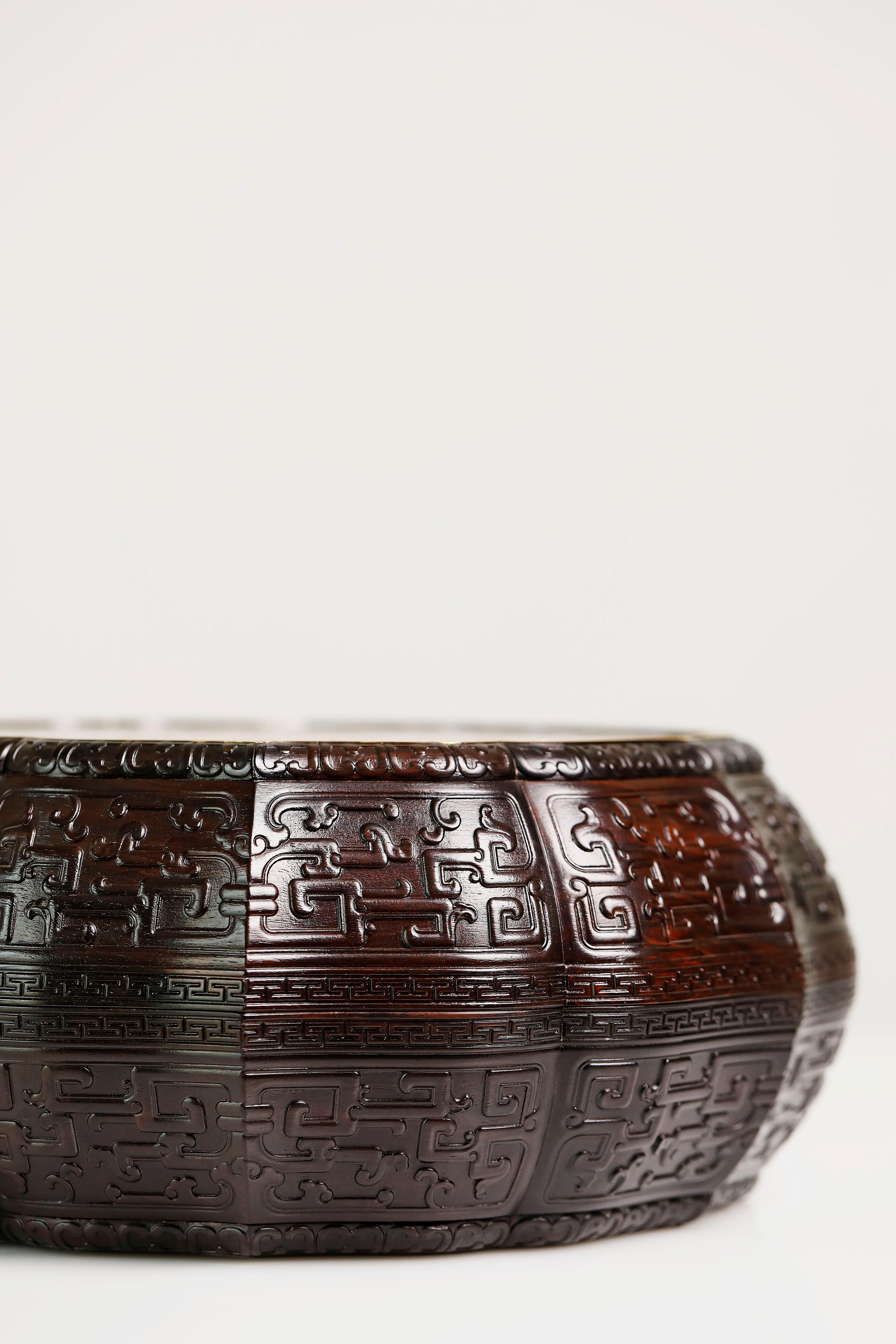 Purple sandalwood twelve-cornered fruit box with gilded Eight Immortals design and sunflower-shaped opening.