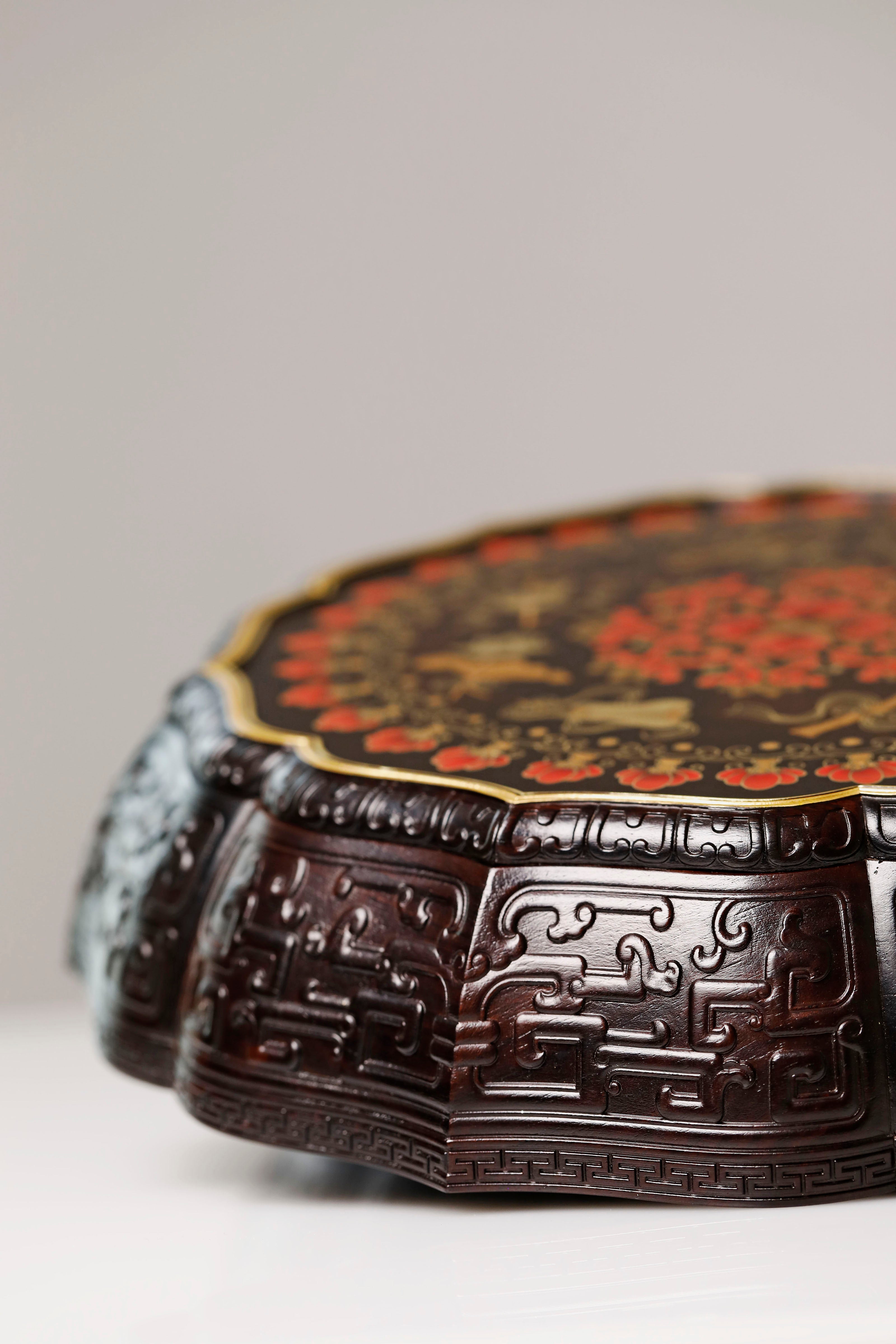 Purple sandalwood twelve-cornered fruit box with gilded Eight Immortals design and sunflower-shaped opening.