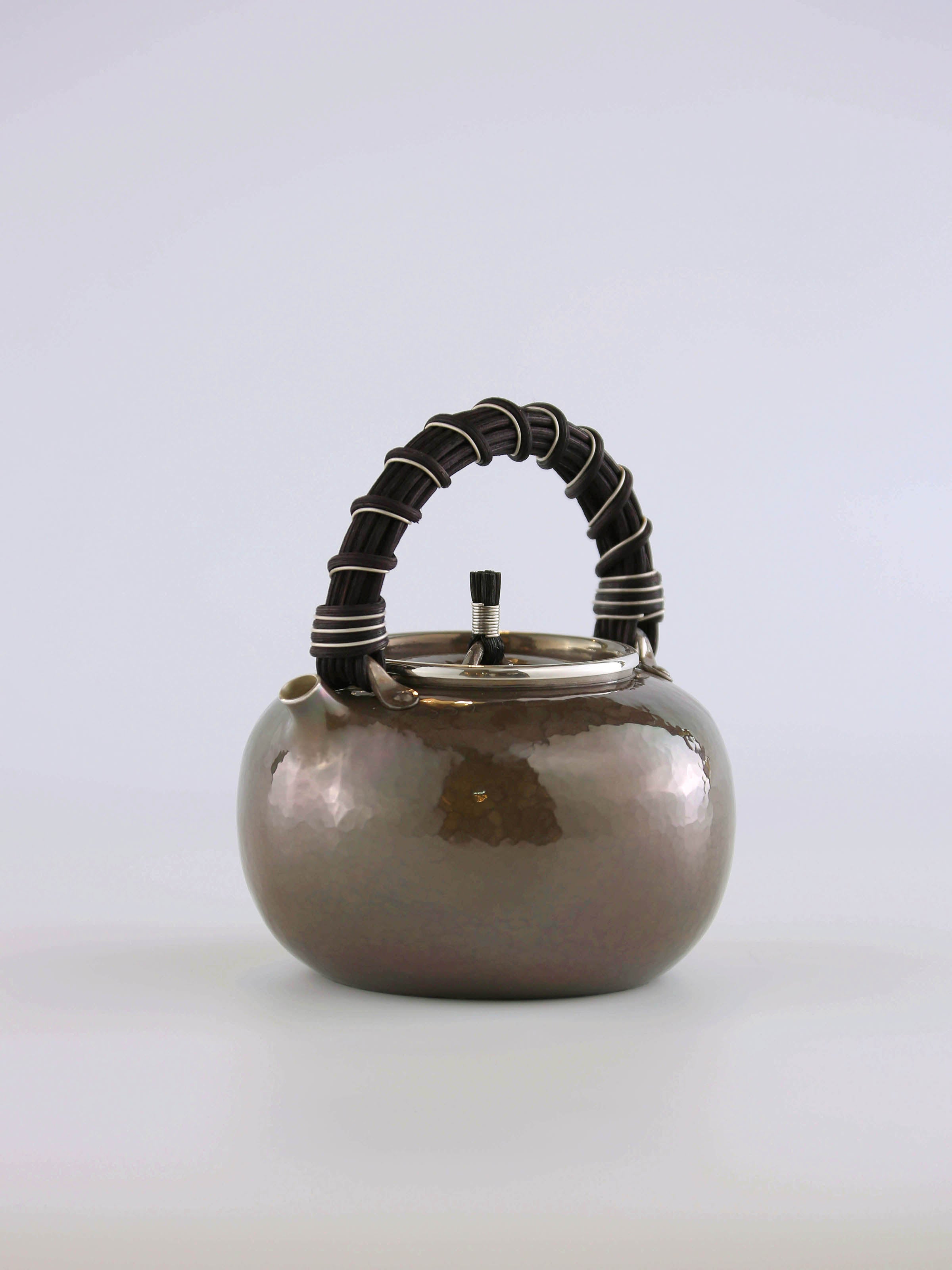 Apple-shaped vine-handled silver teapot