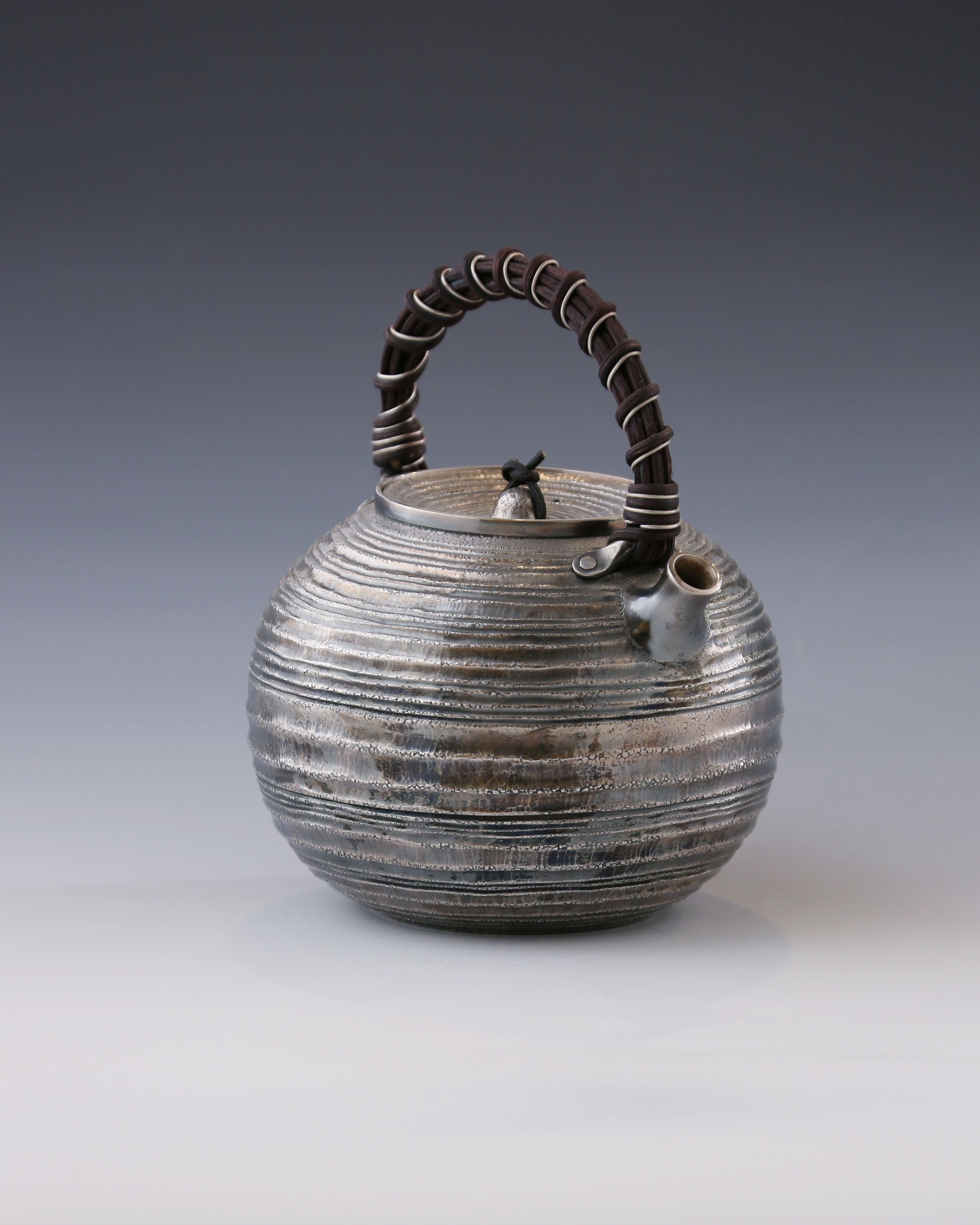 Purple Silver Teapot with Wicker Handle and Swirling Pattern