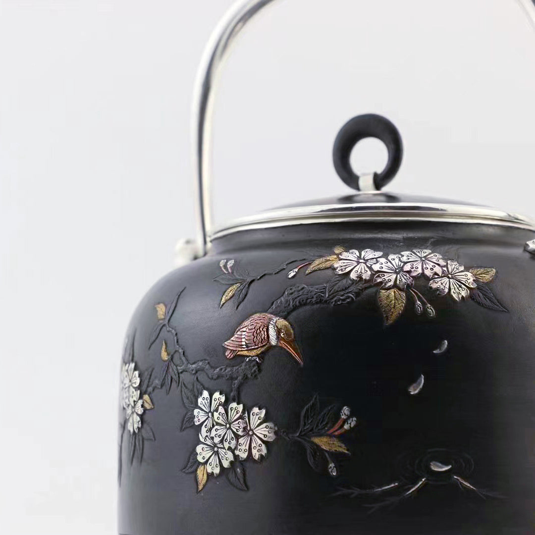 Iron-clad silver flower and bird inlaid gold and silver teapot