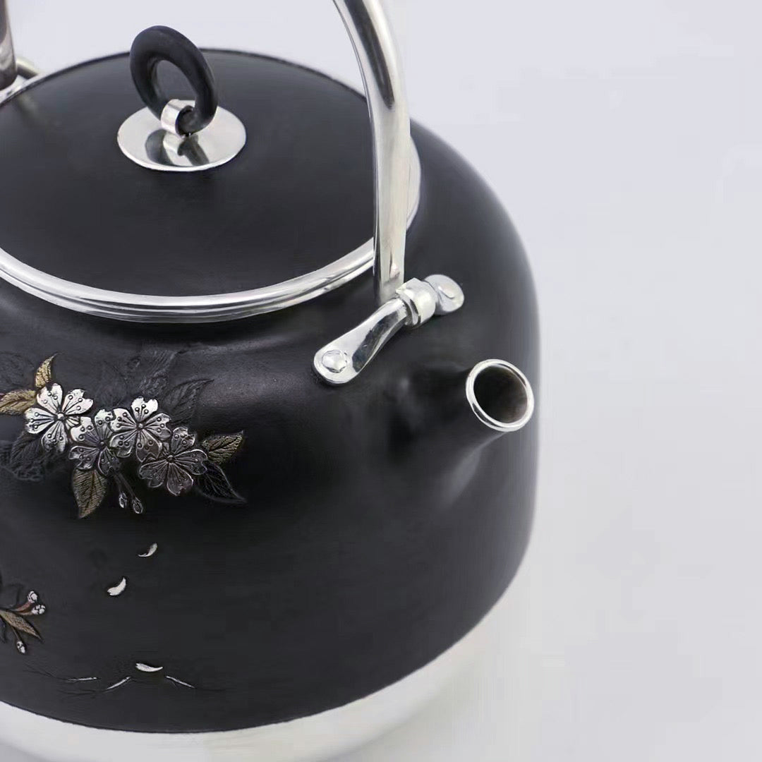 Iron-clad silver flower and bird inlaid gold and silver teapot