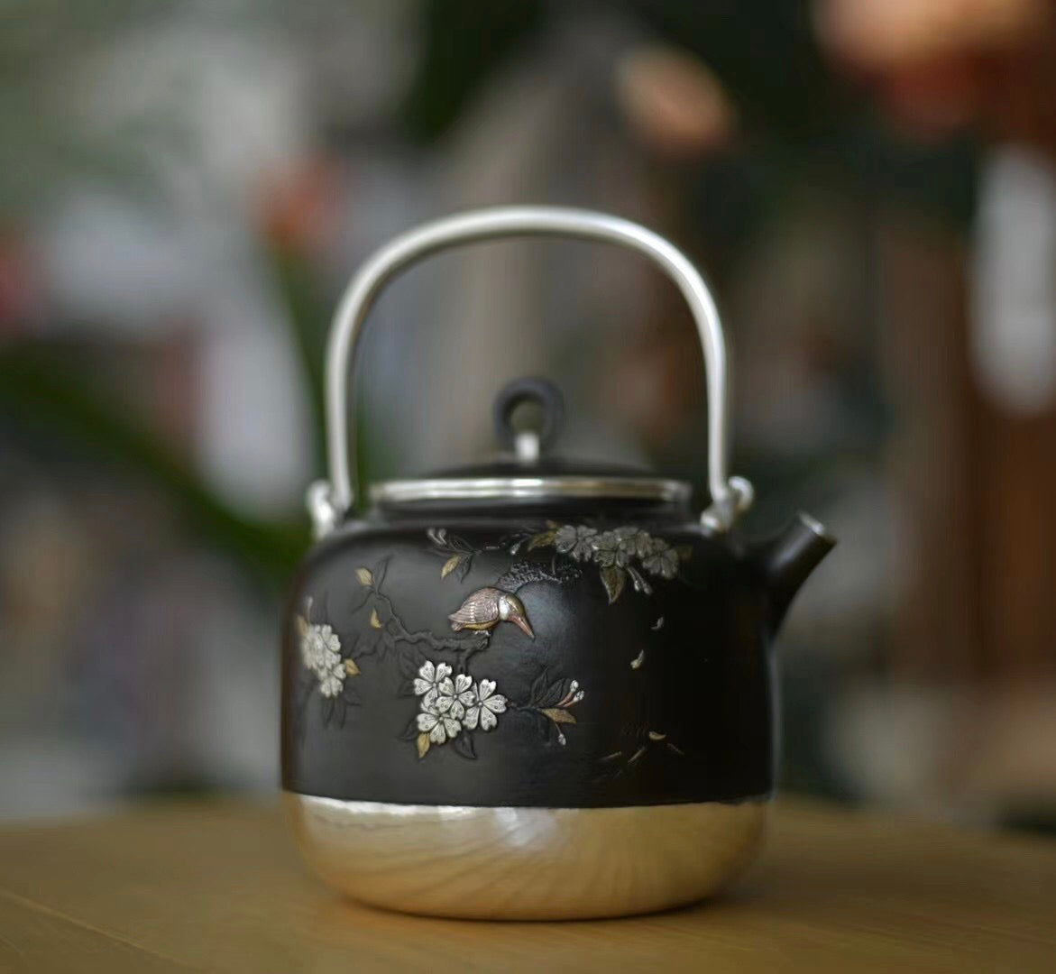 Iron-clad silver flower and bird inlaid gold and silver teapot
