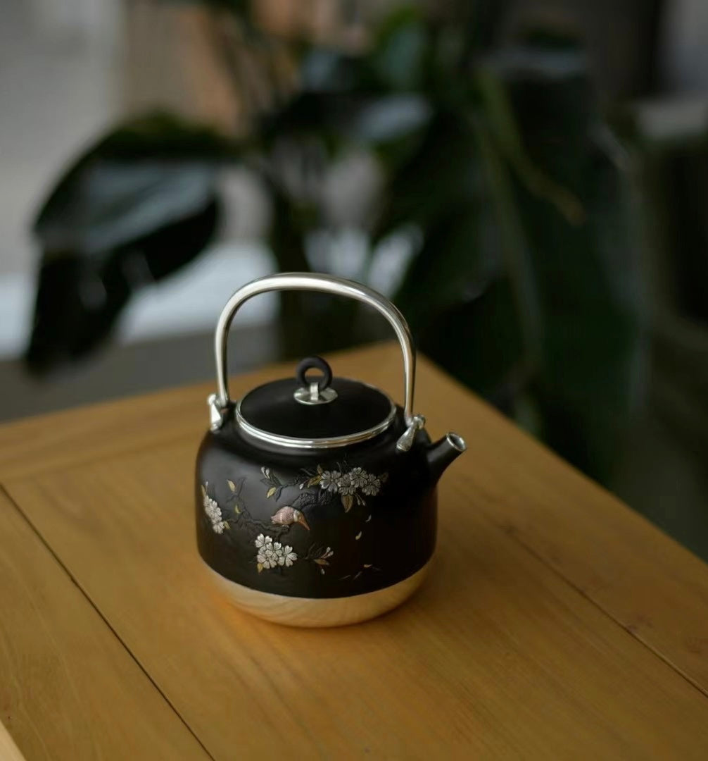 Iron-clad silver flower and bird inlaid gold and silver teapot