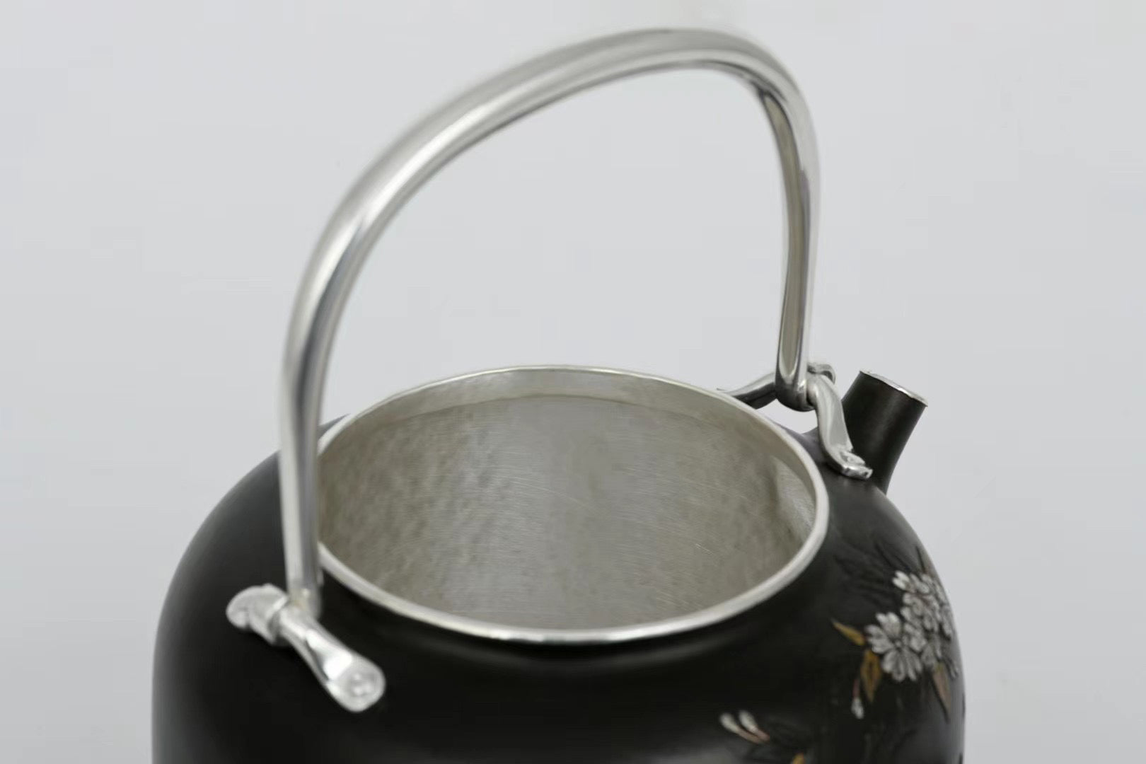 Iron-clad silver flower and bird inlaid gold and silver teapot