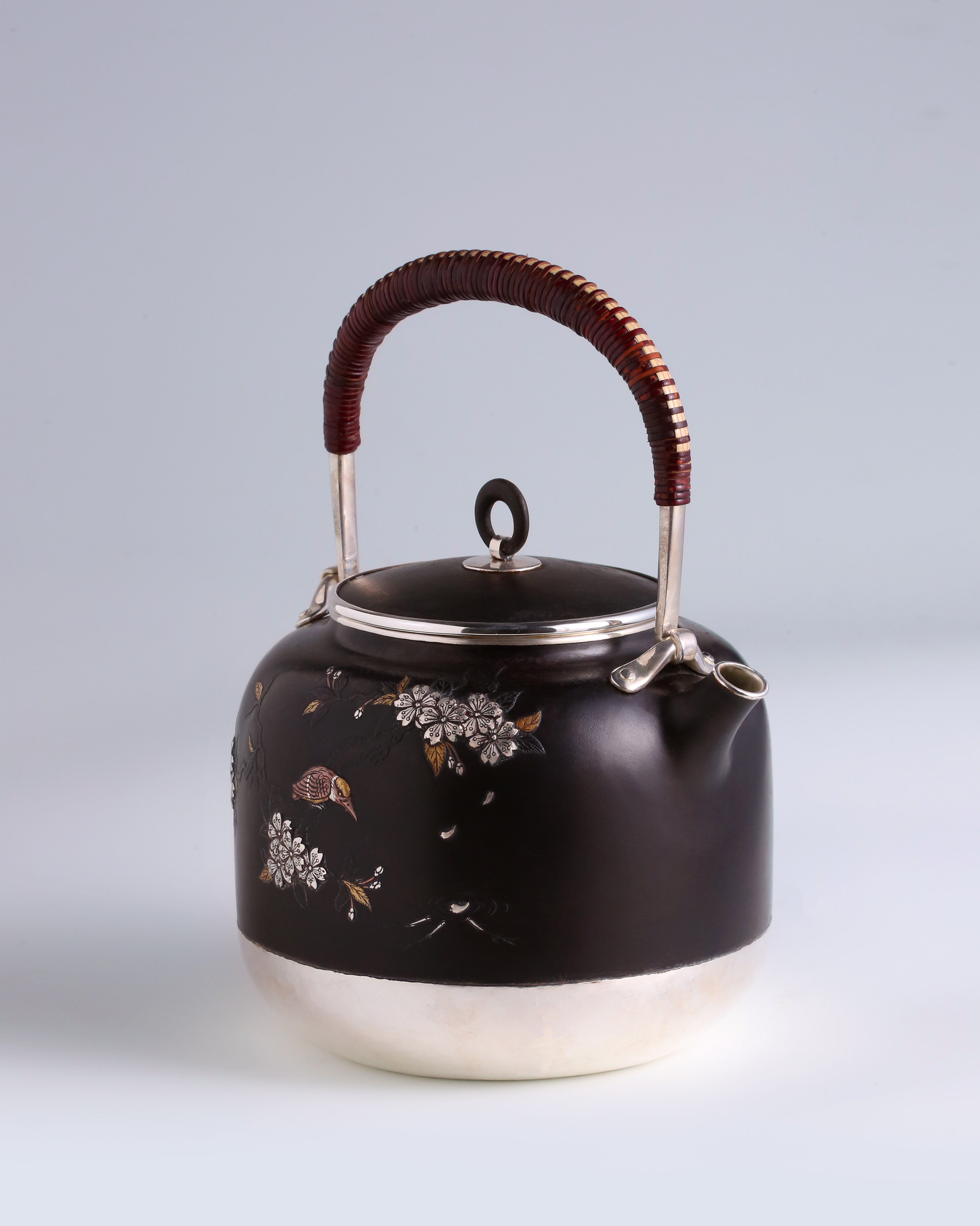 Iron-clad silver flower and bird inlaid gold and silver teapot
