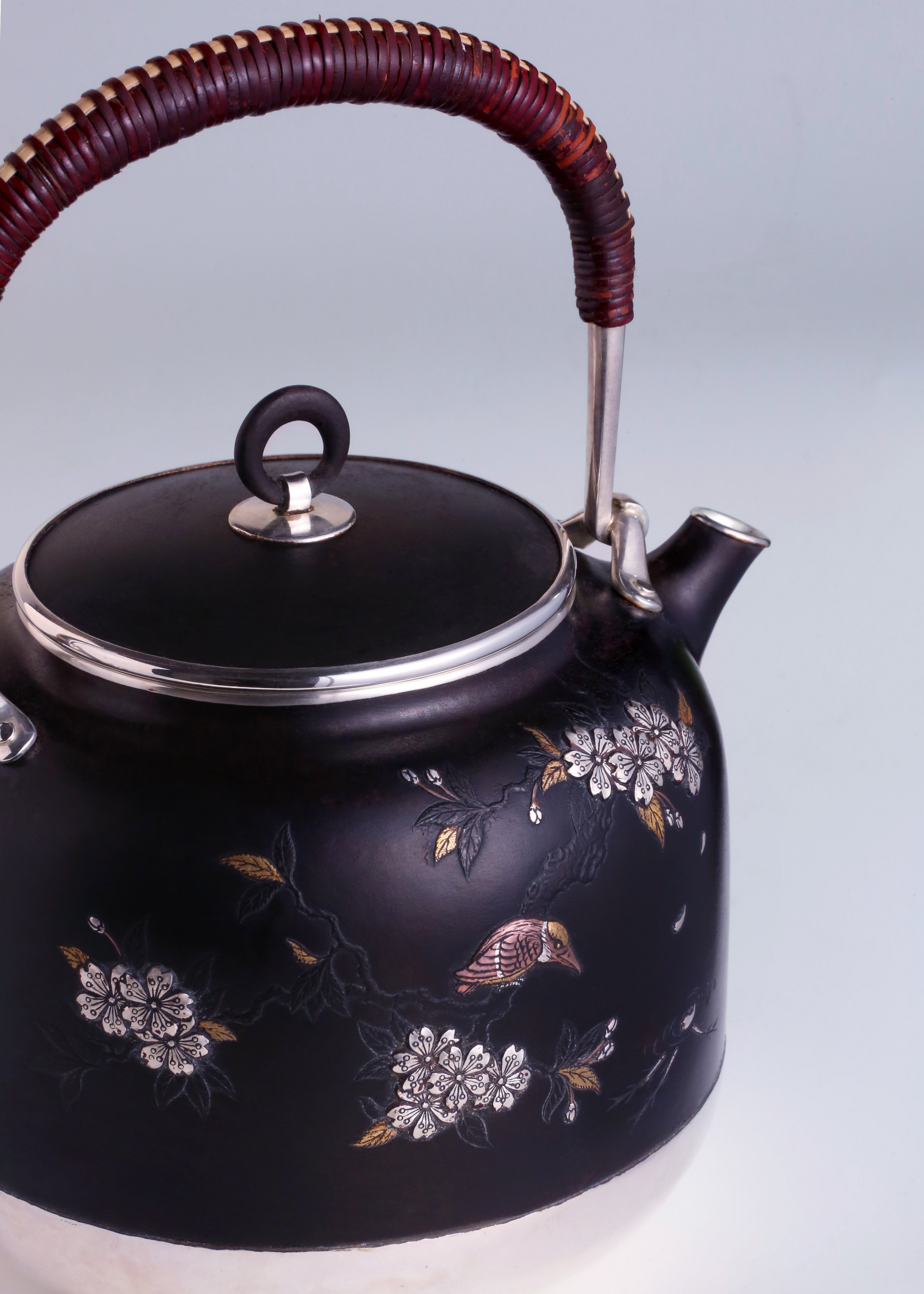 Iron-clad silver flower and bird inlaid gold and silver teapot
