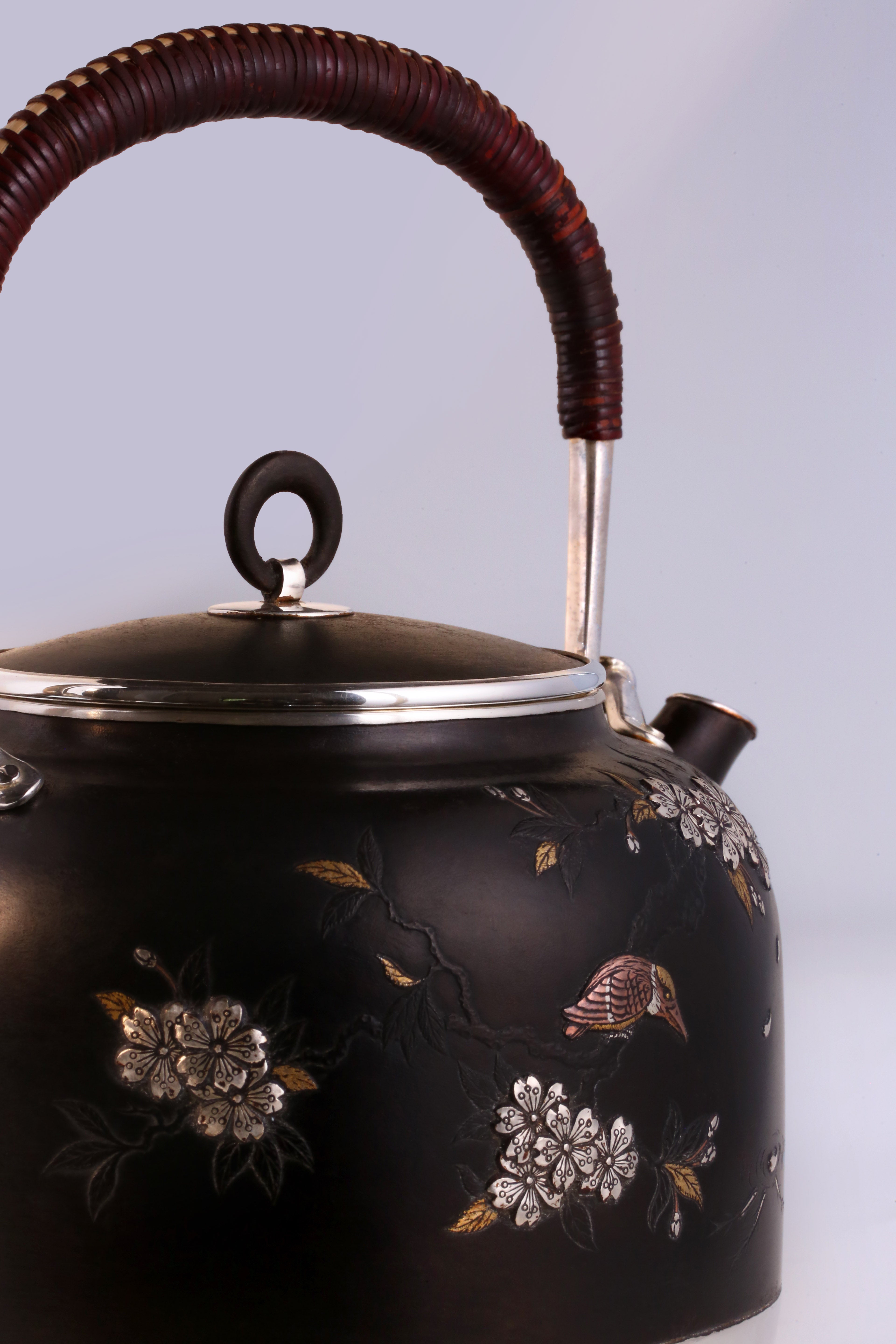 Iron-clad silver flower and bird inlaid gold and silver teapot