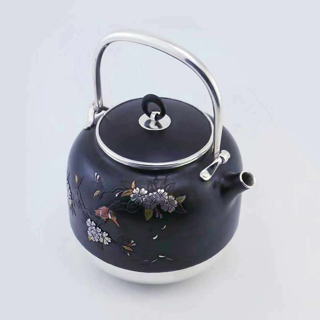 Iron-clad silver flower and bird inlaid gold and silver teapot