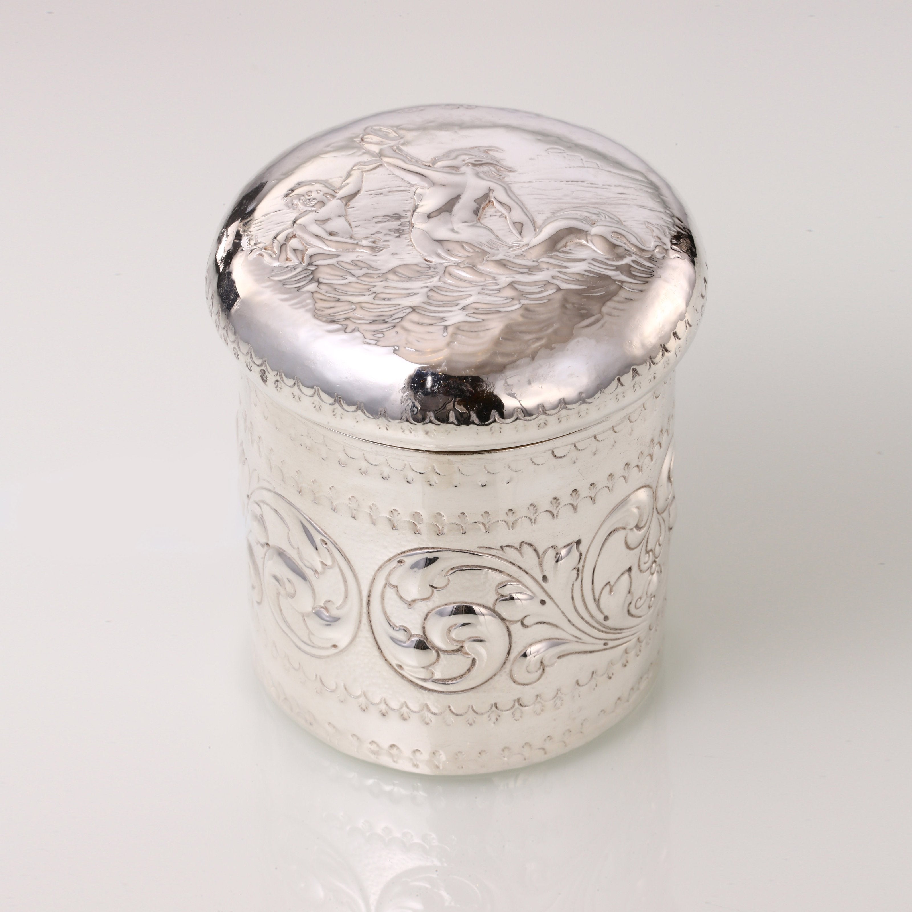 1884 British sterling silver tea caddy with relief floral and figure design