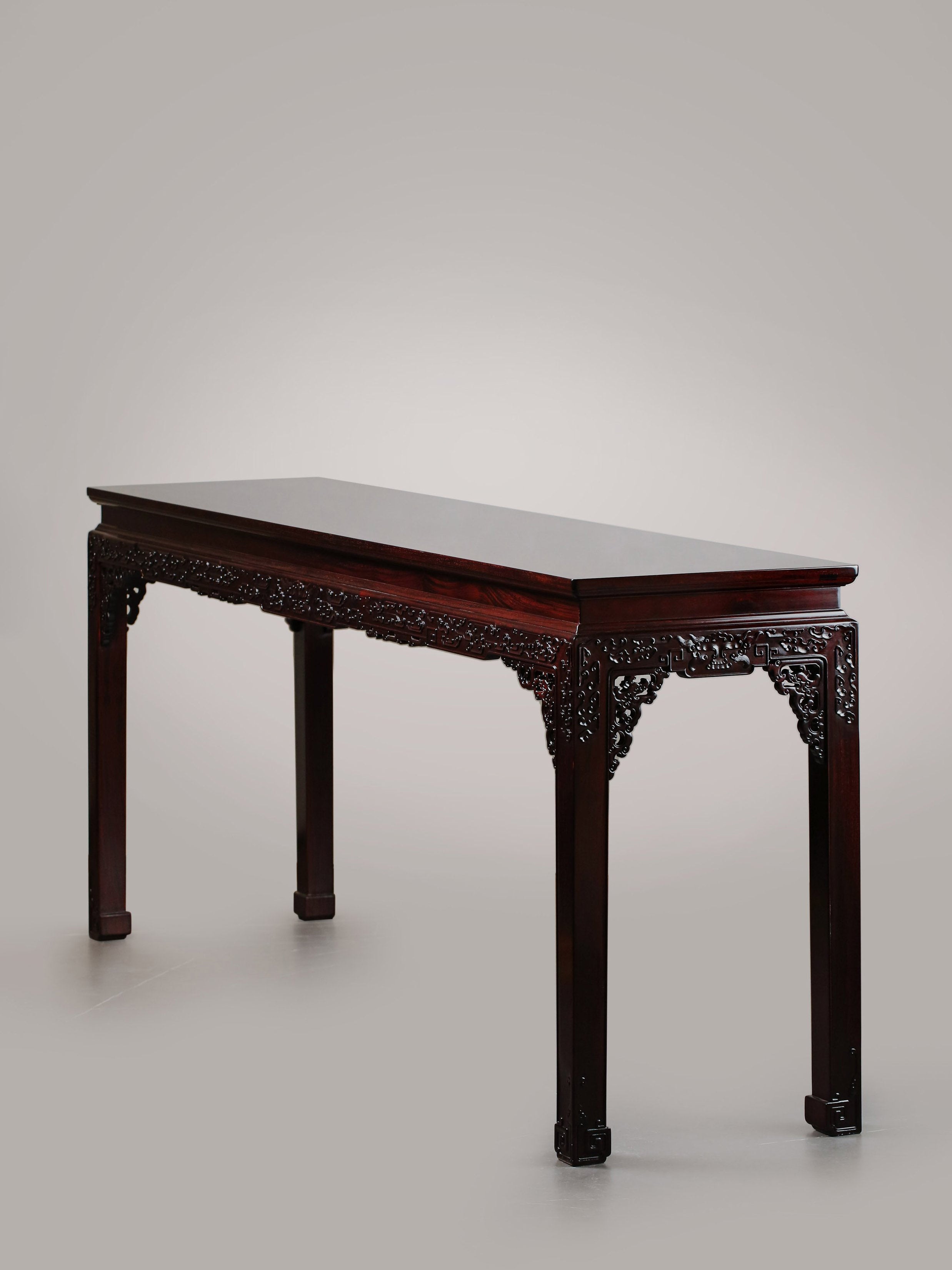 A large rosewood table with taotie design, made for the Qing Dynasty imperial court.