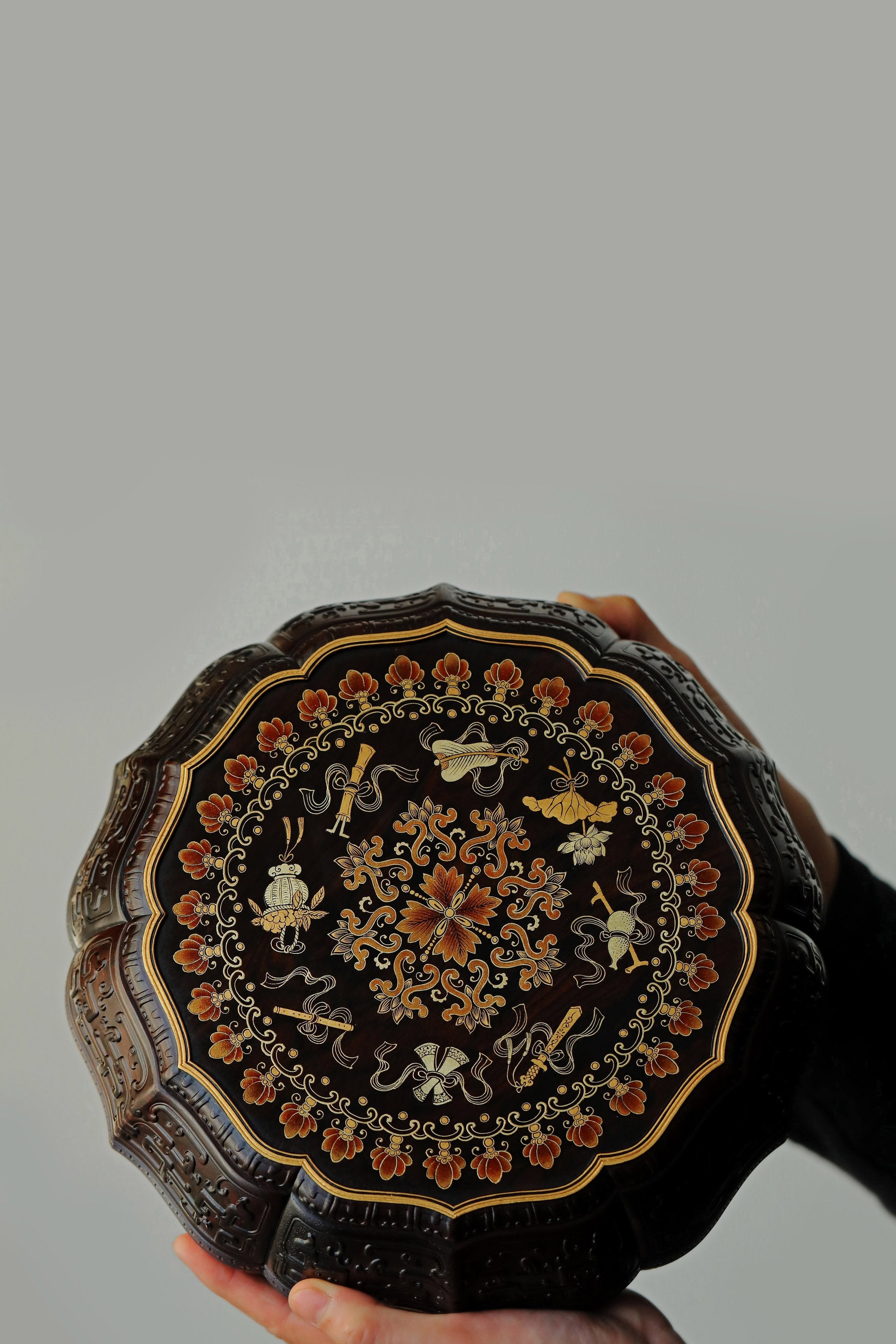 Purple sandalwood twelve-cornered fruit box with gilded Eight Immortals design and sunflower-shaped opening.