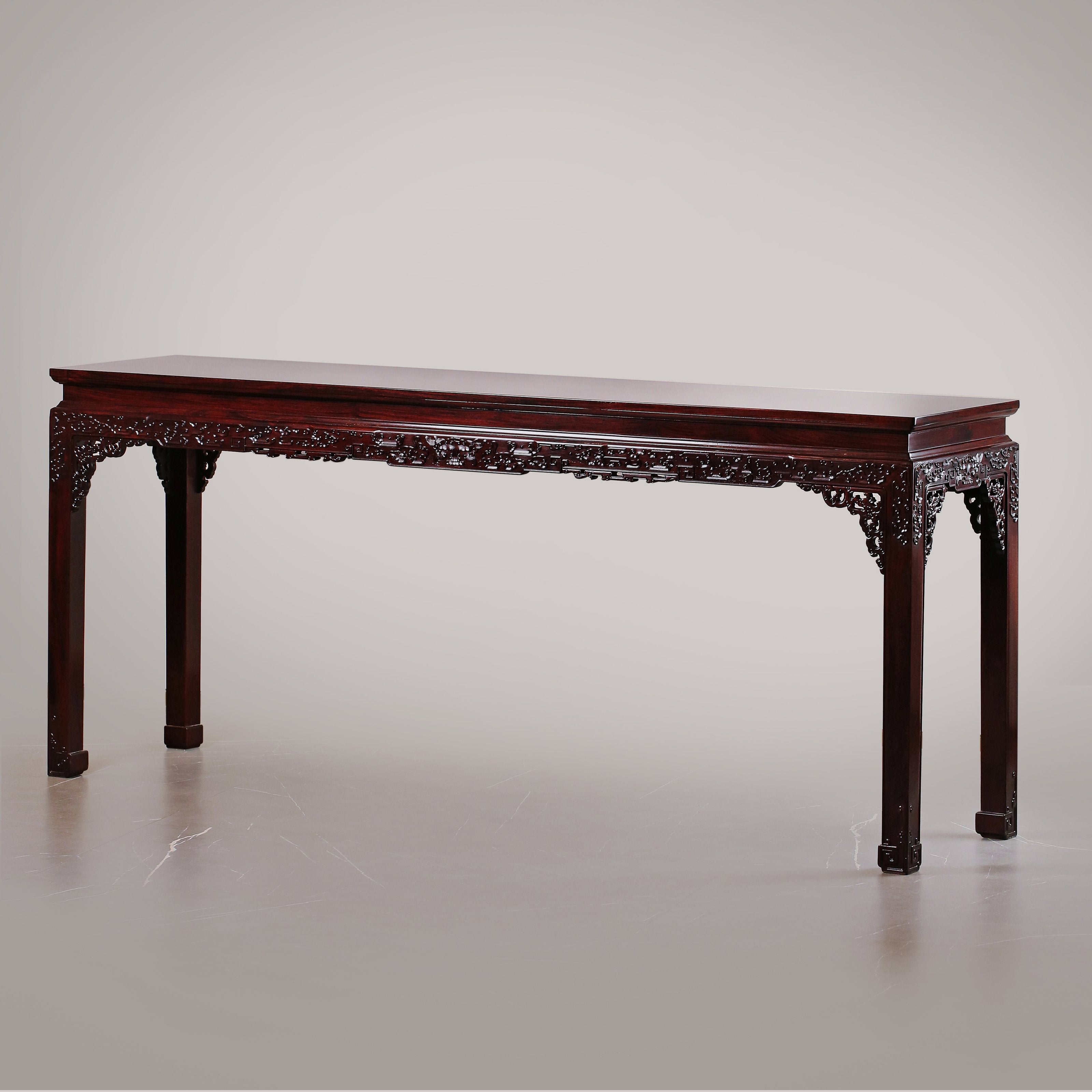 A large rosewood table with taotie design, made for the Qing Dynasty imperial court.
