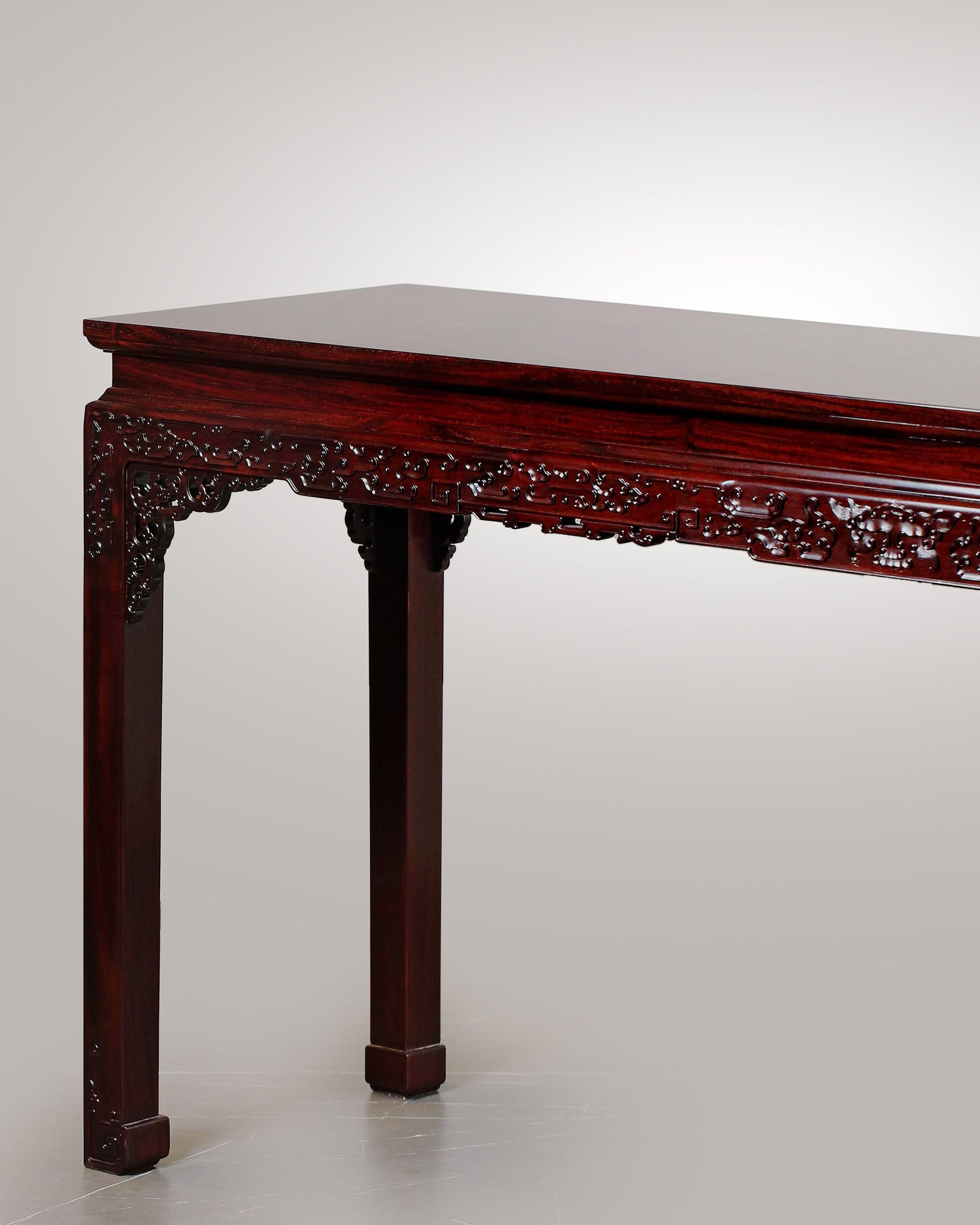 A large rosewood table with taotie design, made for the Qing Dynasty imperial court.
