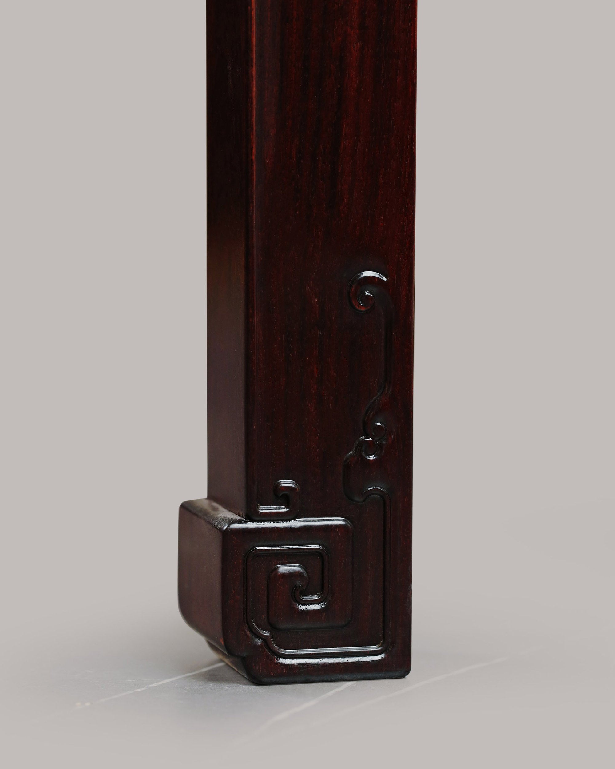 A large rosewood table with taotie design, made for the Qing Dynasty imperial court.