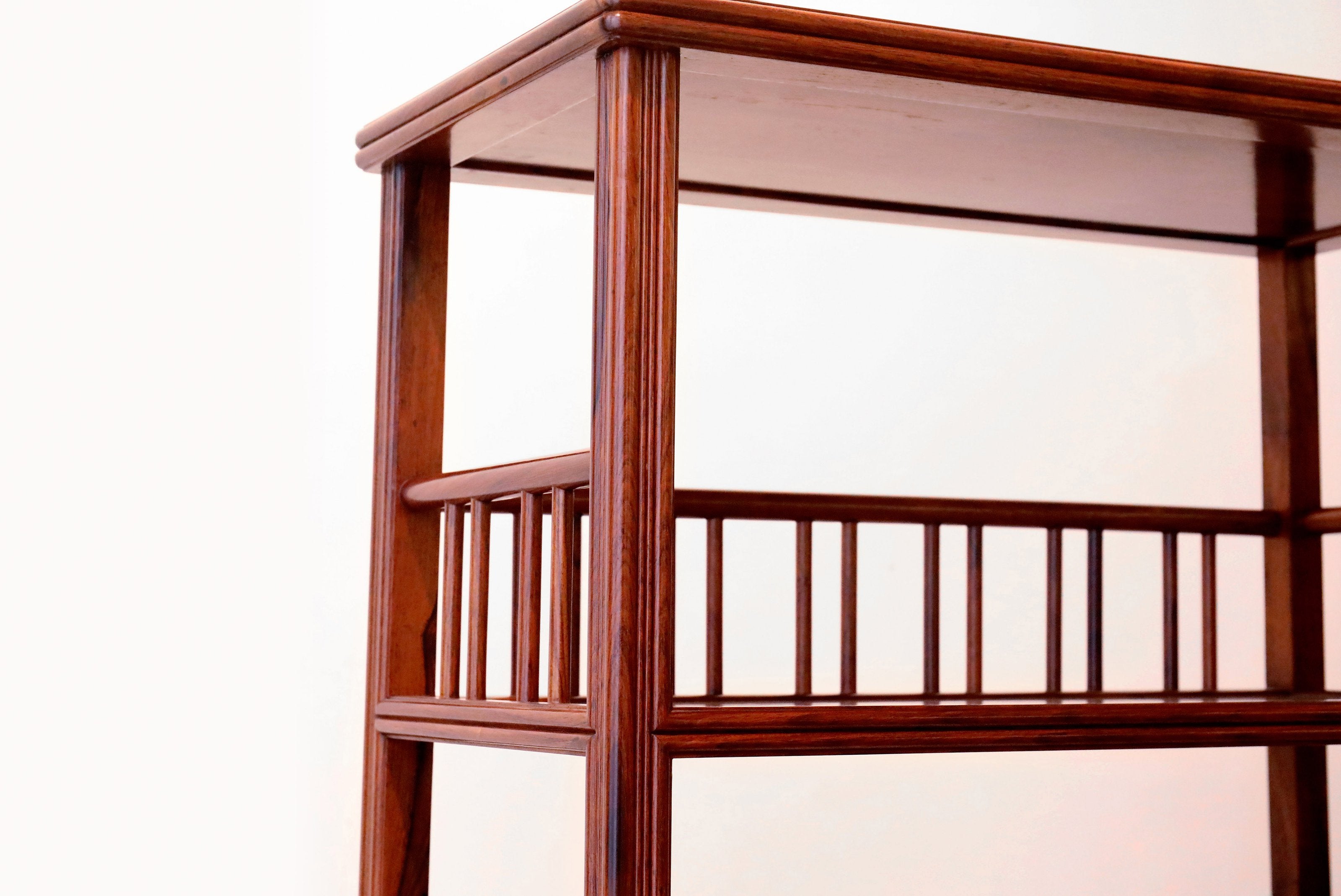 White rosewood branches sparsely sprout from the bottom of the scholar's desk.